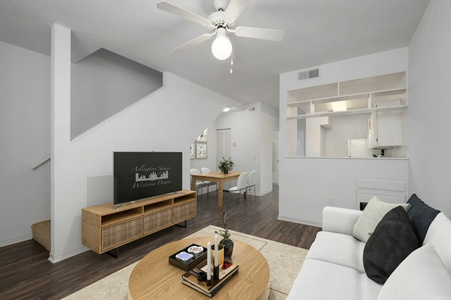 Living room with tv, couch, dining area and upstairs