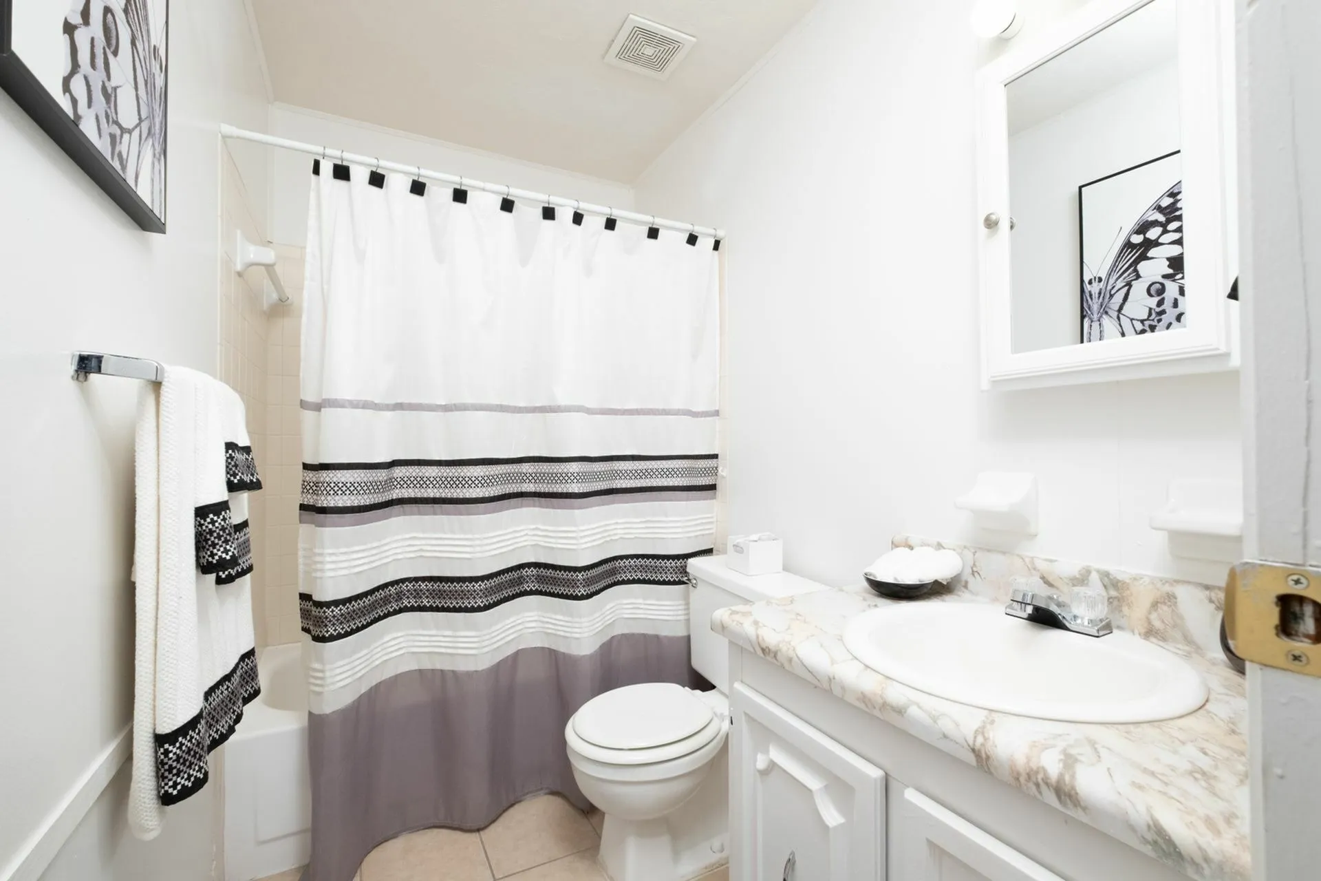 Bathroom with vinyl countertop and blue shower curtain