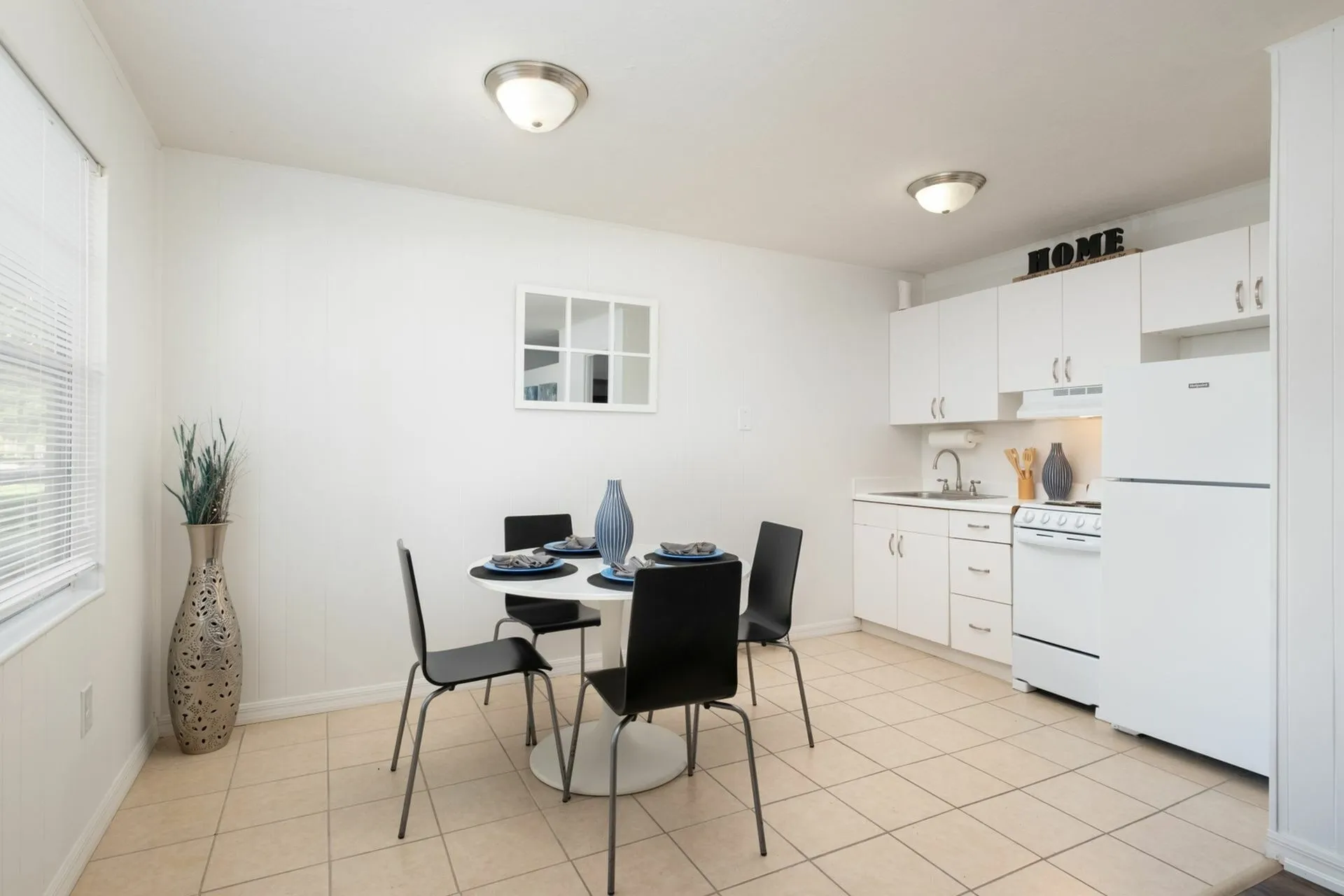 Kitchen/dining area with black chairs and dining table