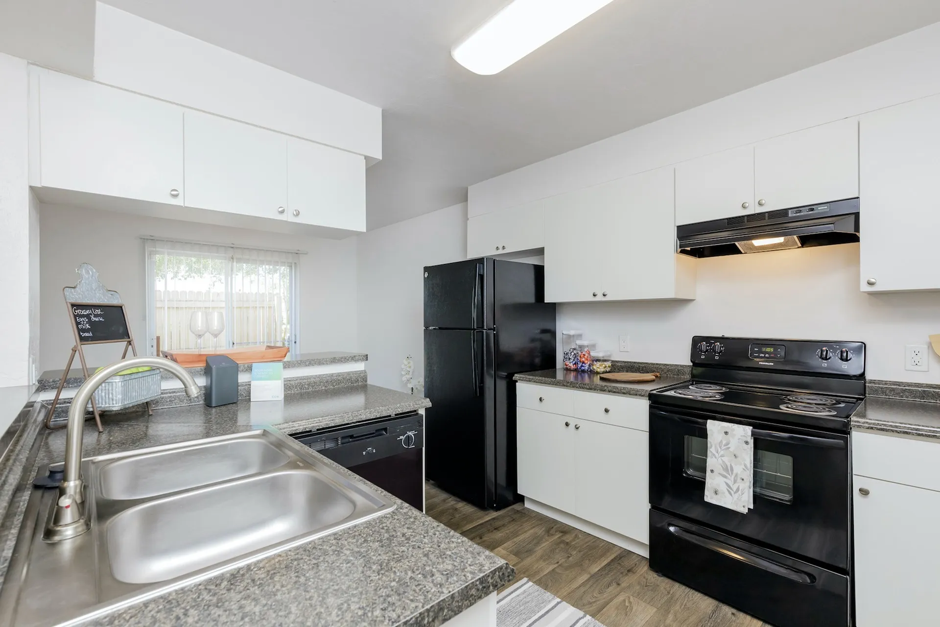 kitchen with black appliances and vinyl countertops