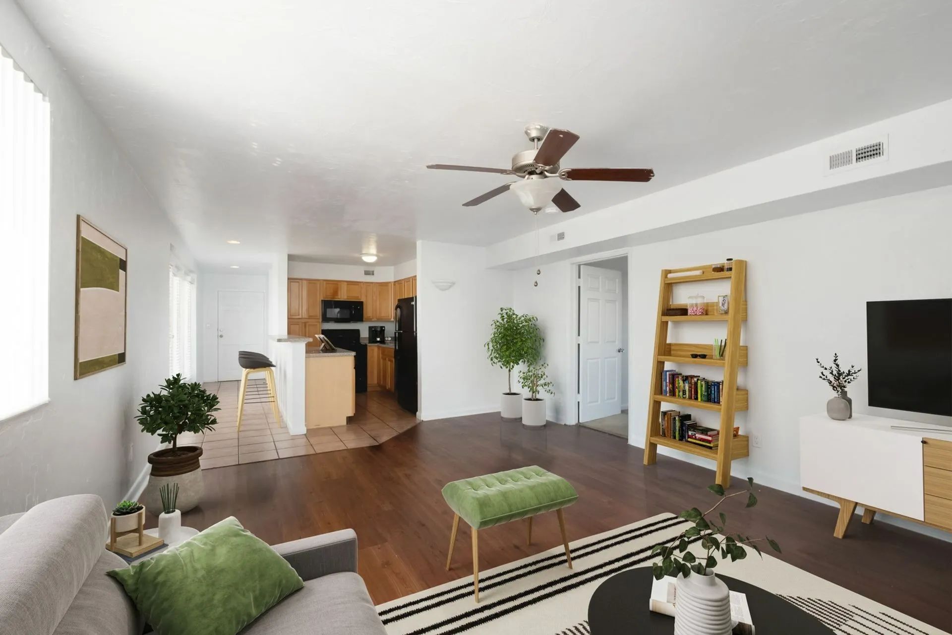 Penthouse living room with couch and tv and kitchen