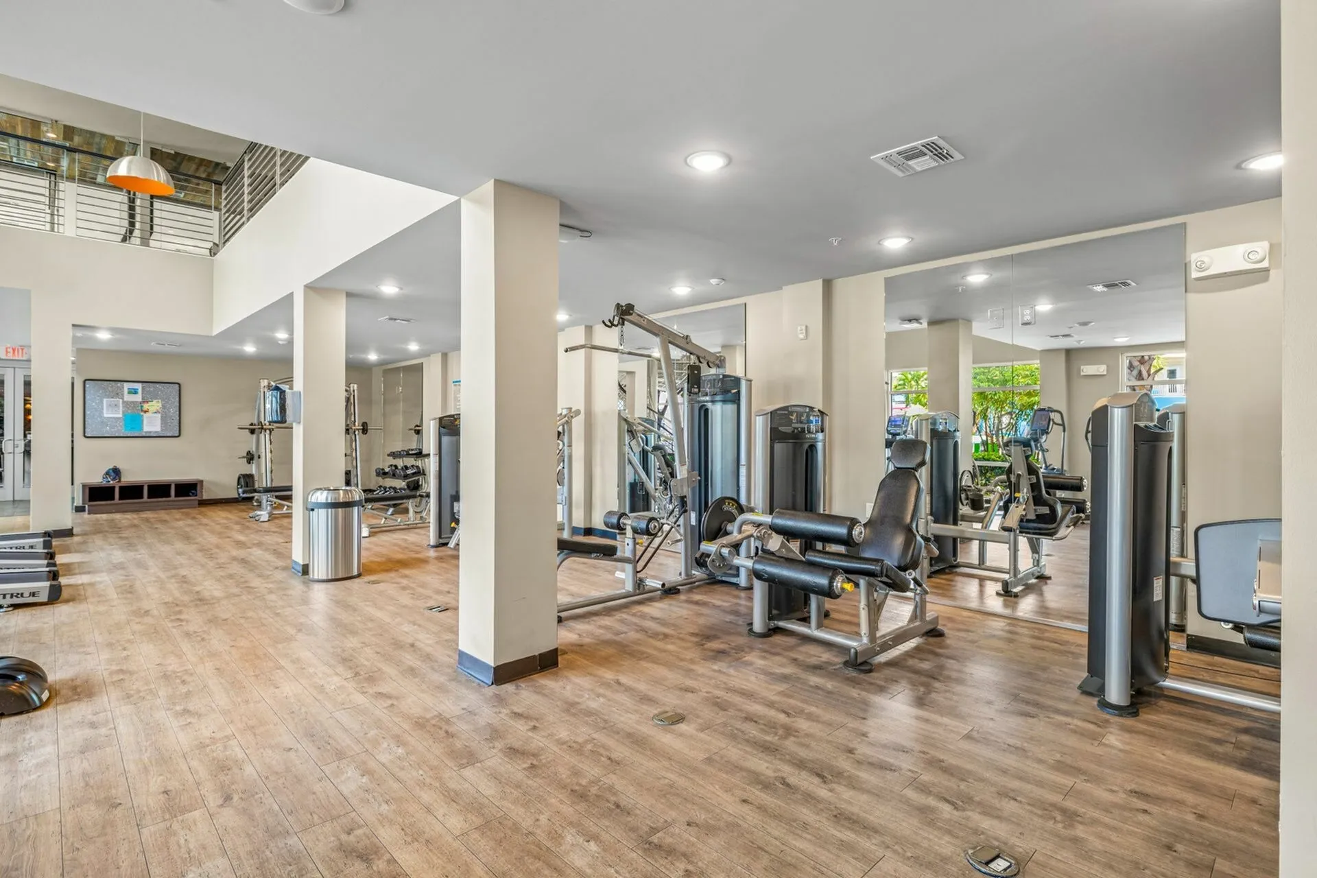 Community fitness center with various cardio and weight machines.