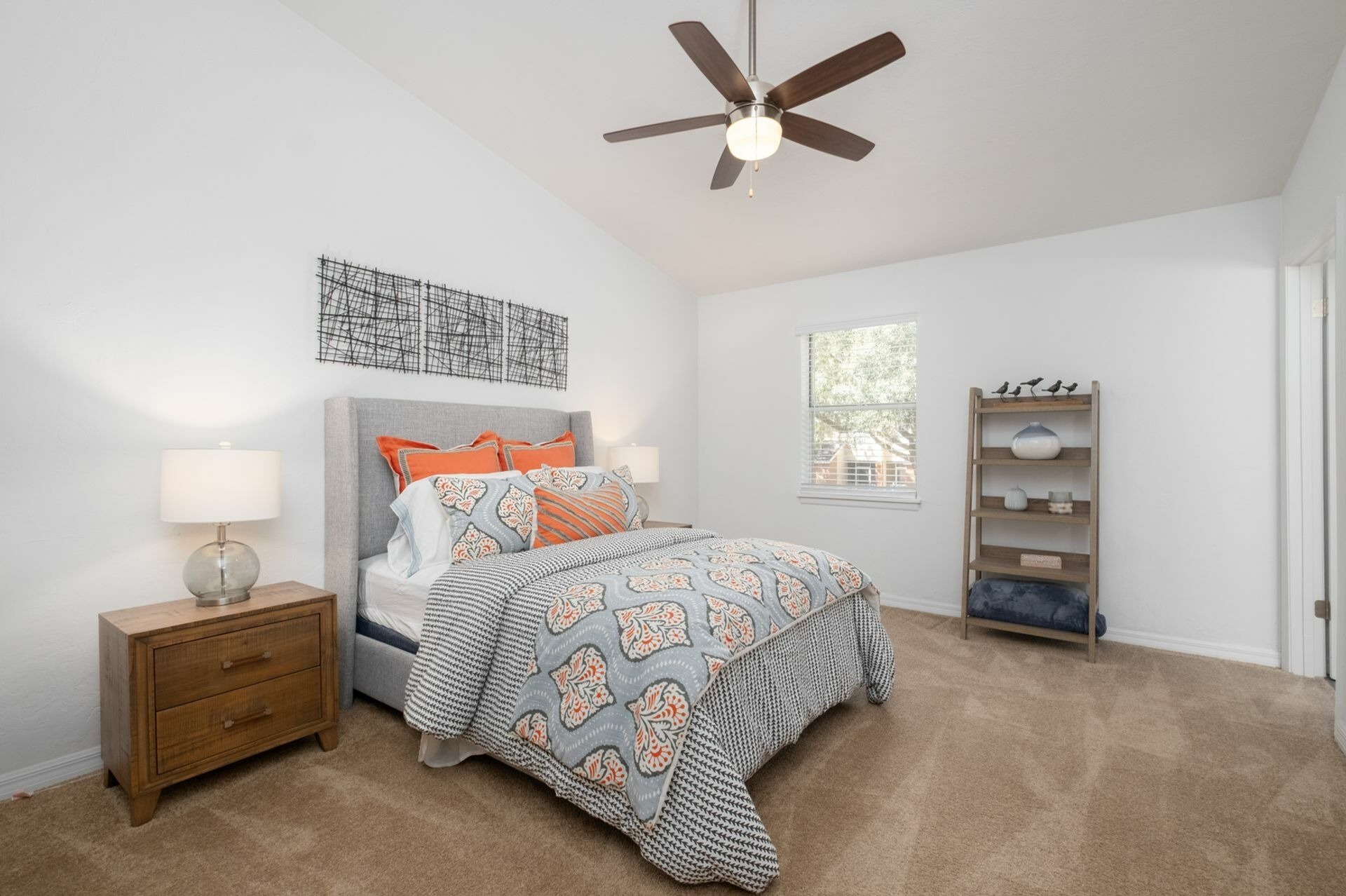 Bedroom with blue bed, window, and shelf