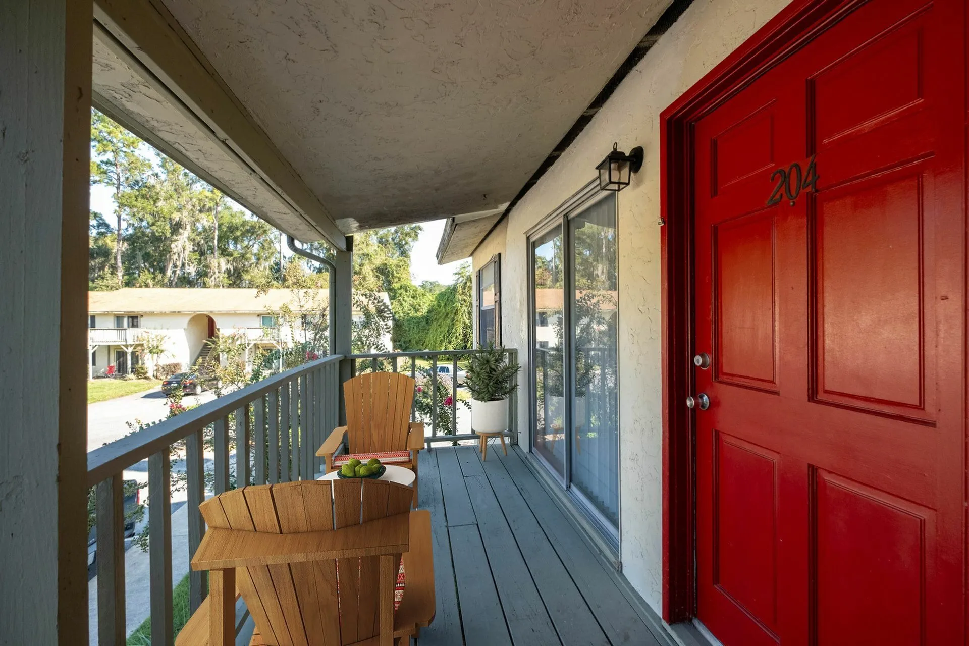 Balcony with furniture and red door