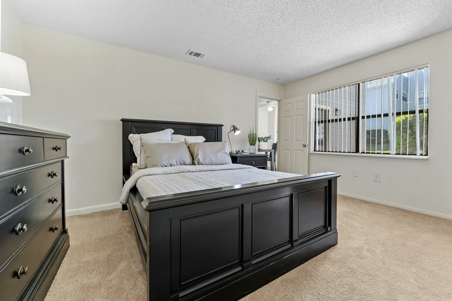 Carpeted bedroom with modern furniture. .