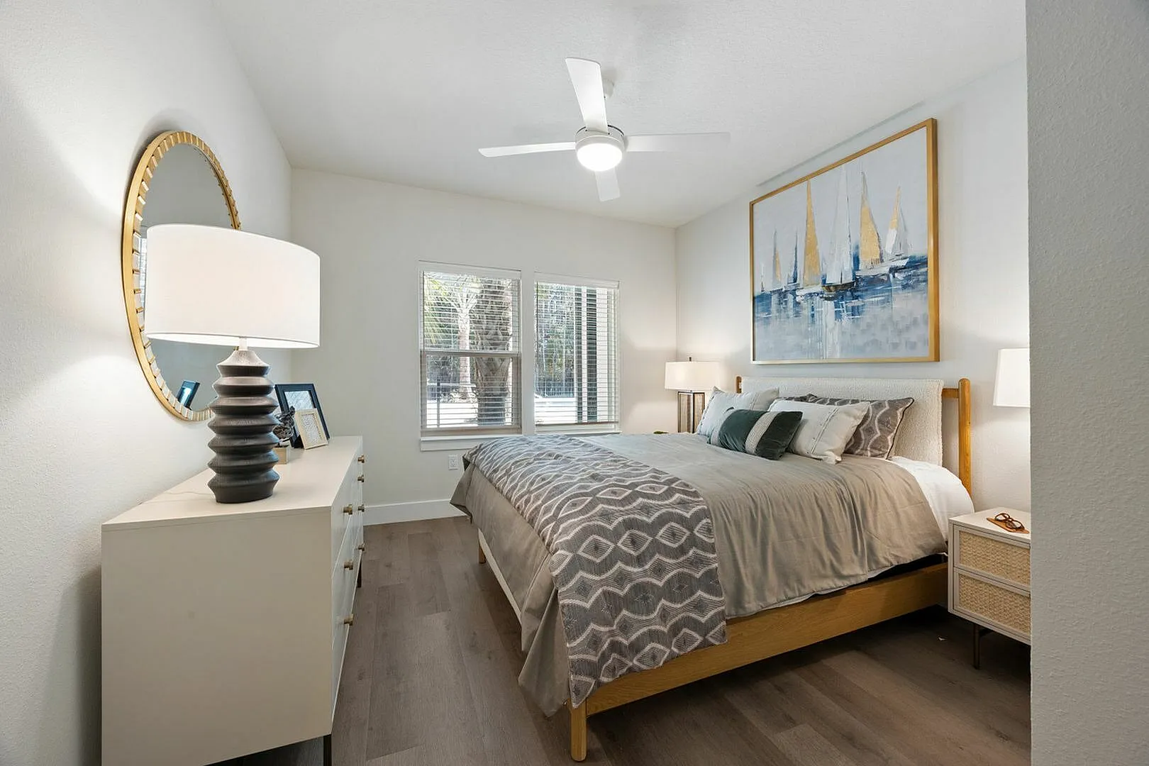 Inviting bedroom with contemporary decor, featuring a comfortable bed, stylish dresser, and wall art.