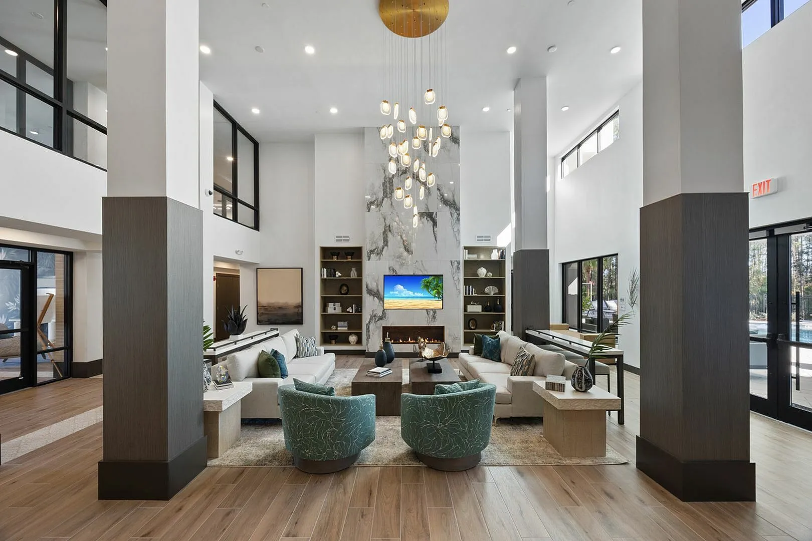 Luxurious high-ceiling lounge with modern decor, plush seating, and stylish chandelier.