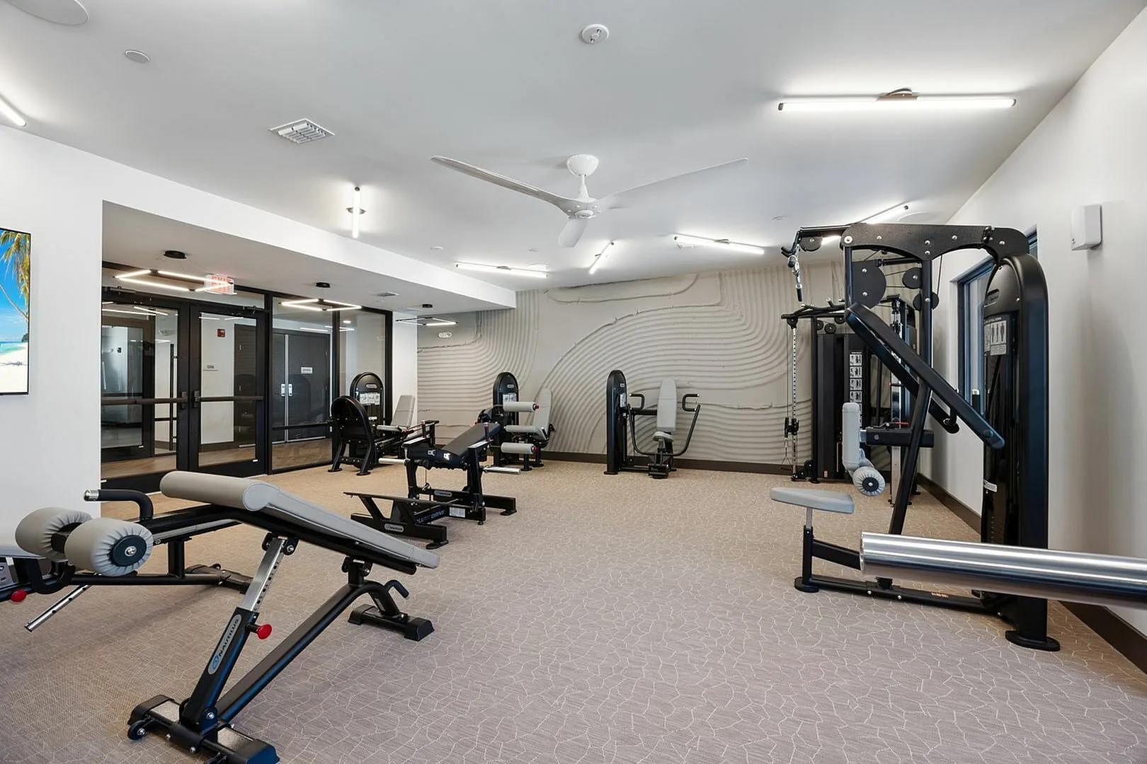 Modern gym featuring high-end fitness equipment and spacious interior with stylish decor.