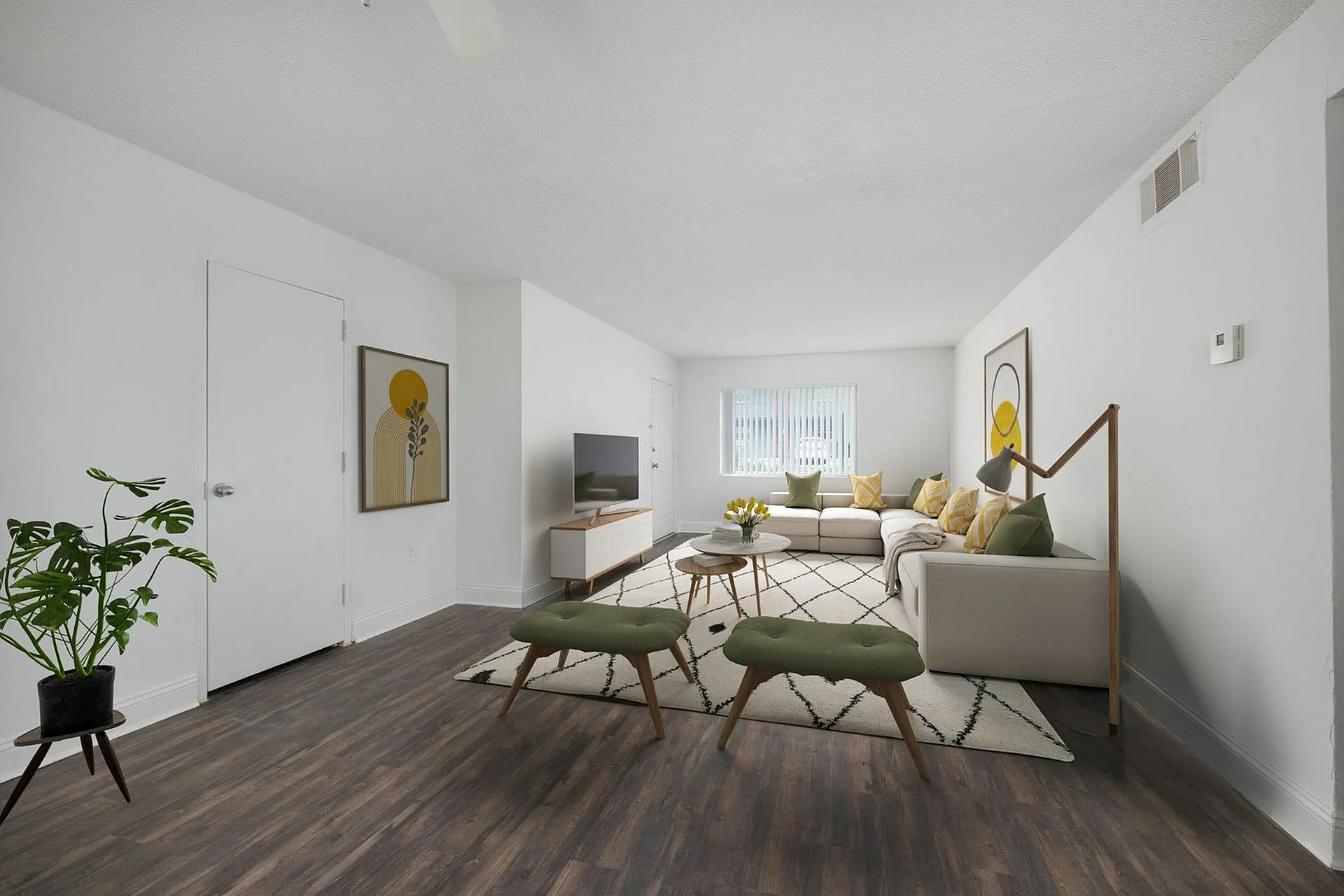 Bright, stylish living room with a spacious L-shaped sofa, modern decor, and a large window.