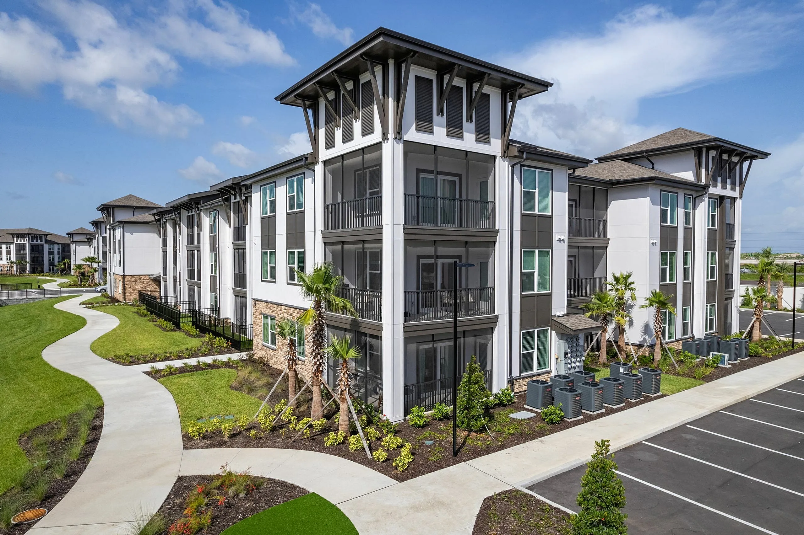 Elegant modern apartment complex with sleek architecture, lush landscaped pathways, and abundant natural light.