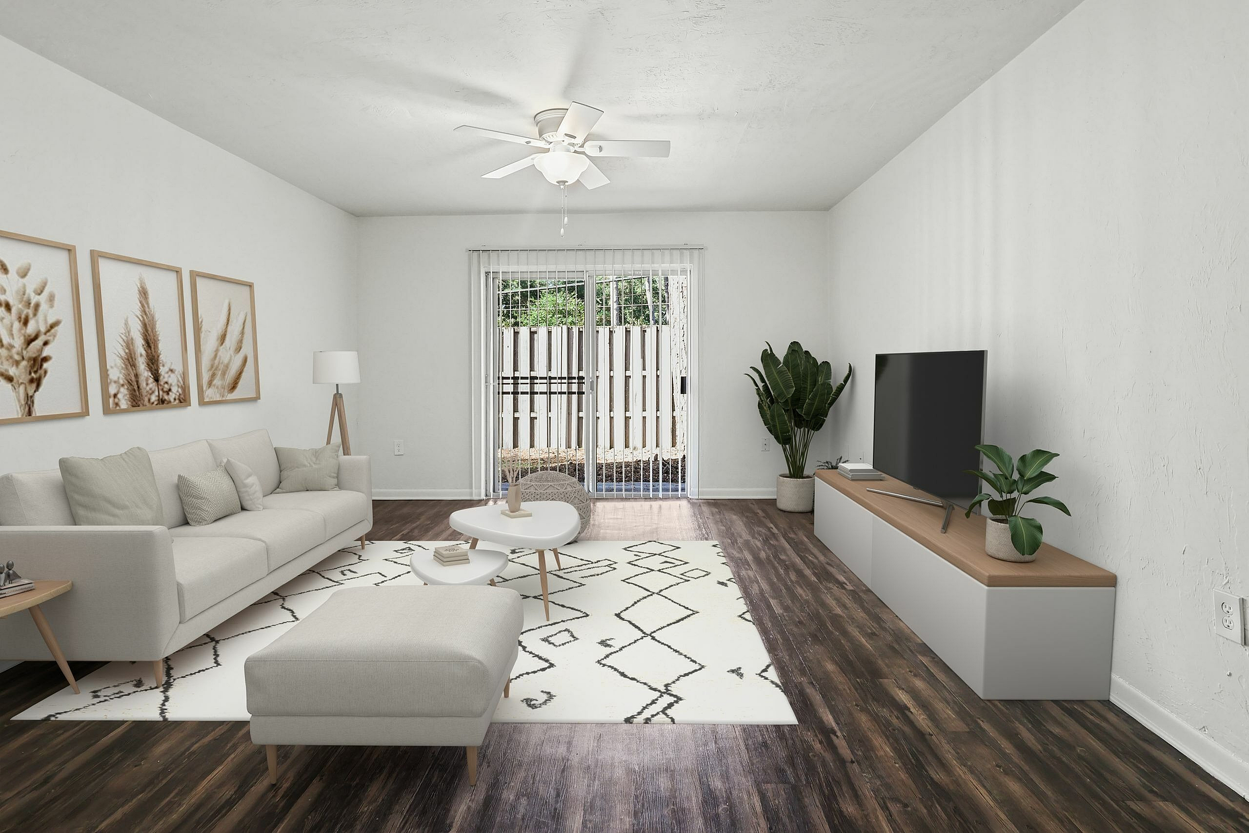 Elegant living room with chic decor, comfortable sofa, and stylish entertainment center overlooking a cozy patio.