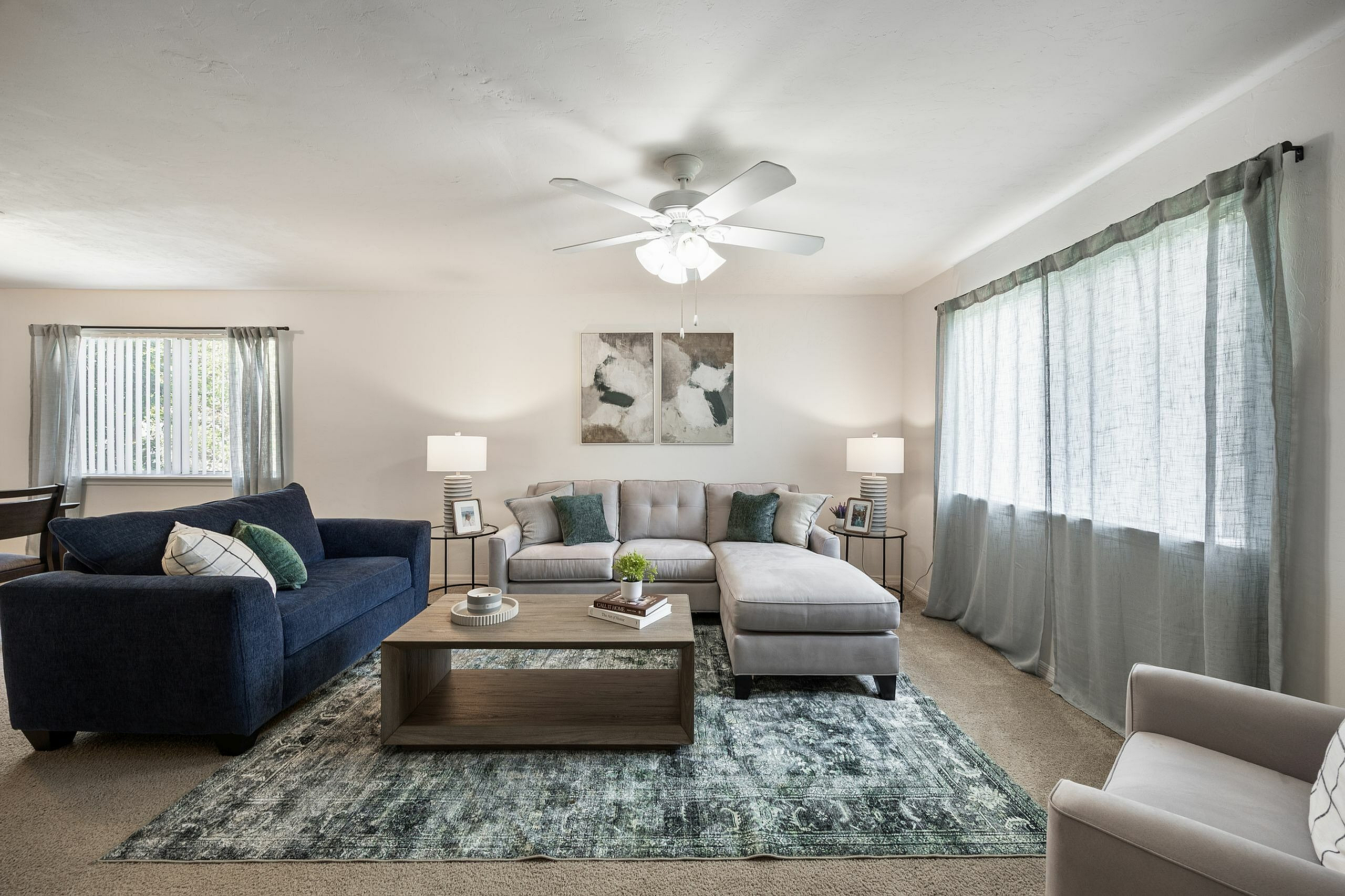 Elegant living room with modern furnishings, featuring a large comfy sectional, plush accent pillows, and soft natural lighting.