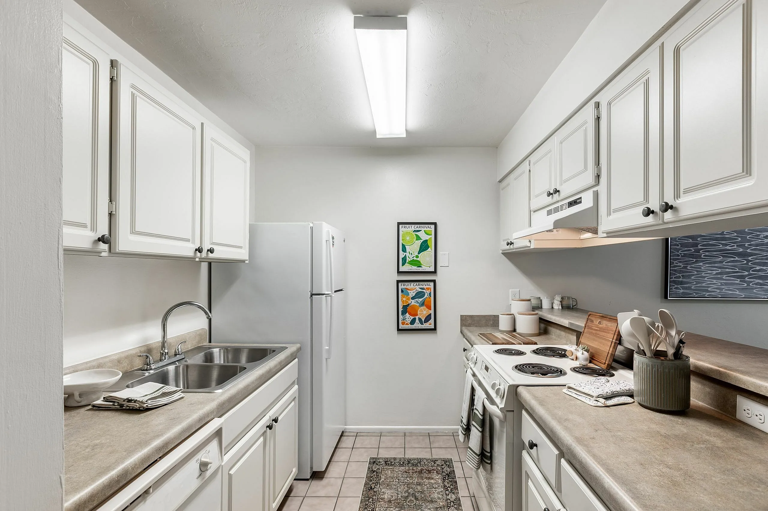 Chic and cozy kitchen with modern white cabinets, electric stove, and elegant decor, exuding a warm and inviting atmosphere.