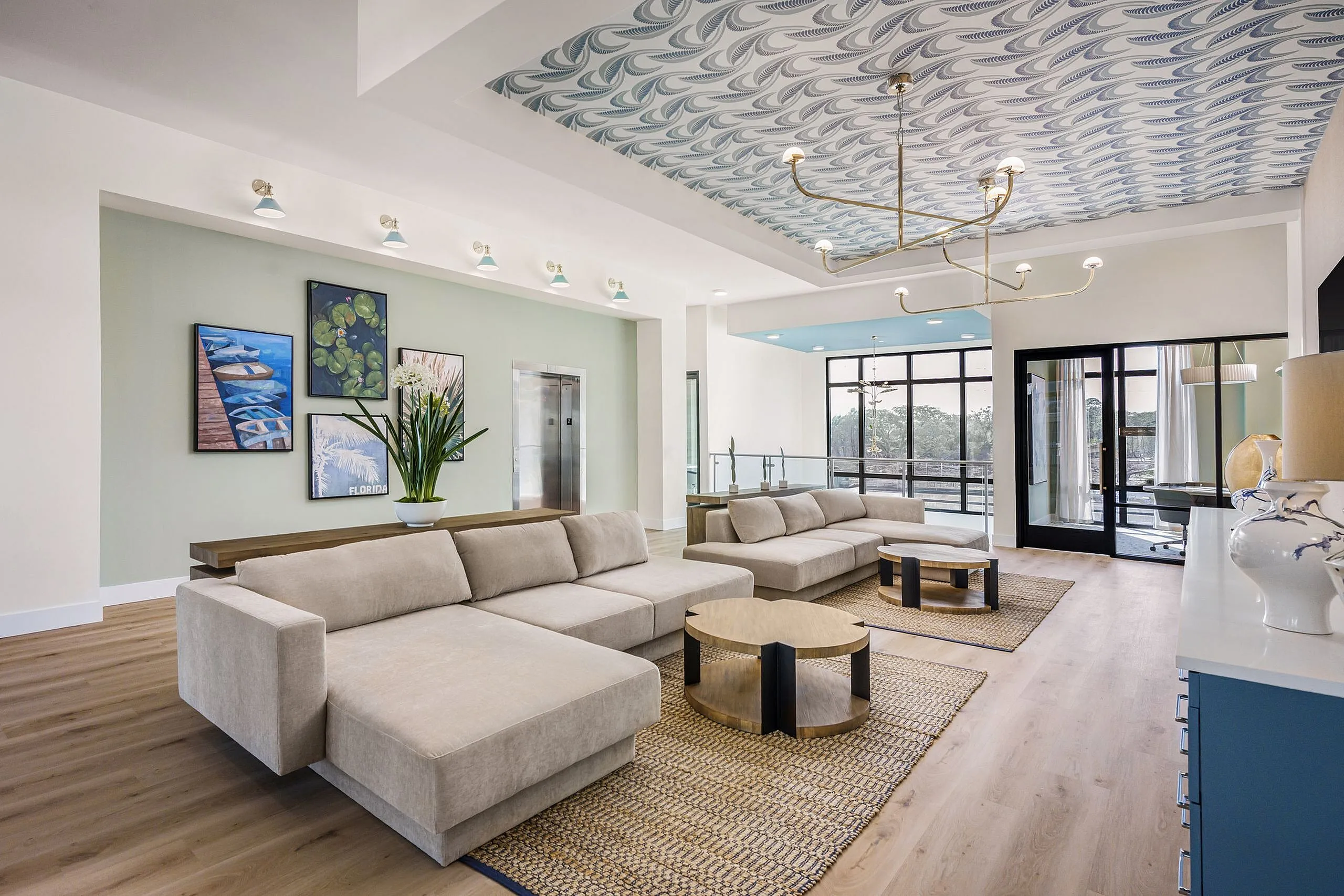 Luxurious living room with chic beige sofas, stylish patterned ceiling, and elegant decor offering a modern and inviting atmosphere.
