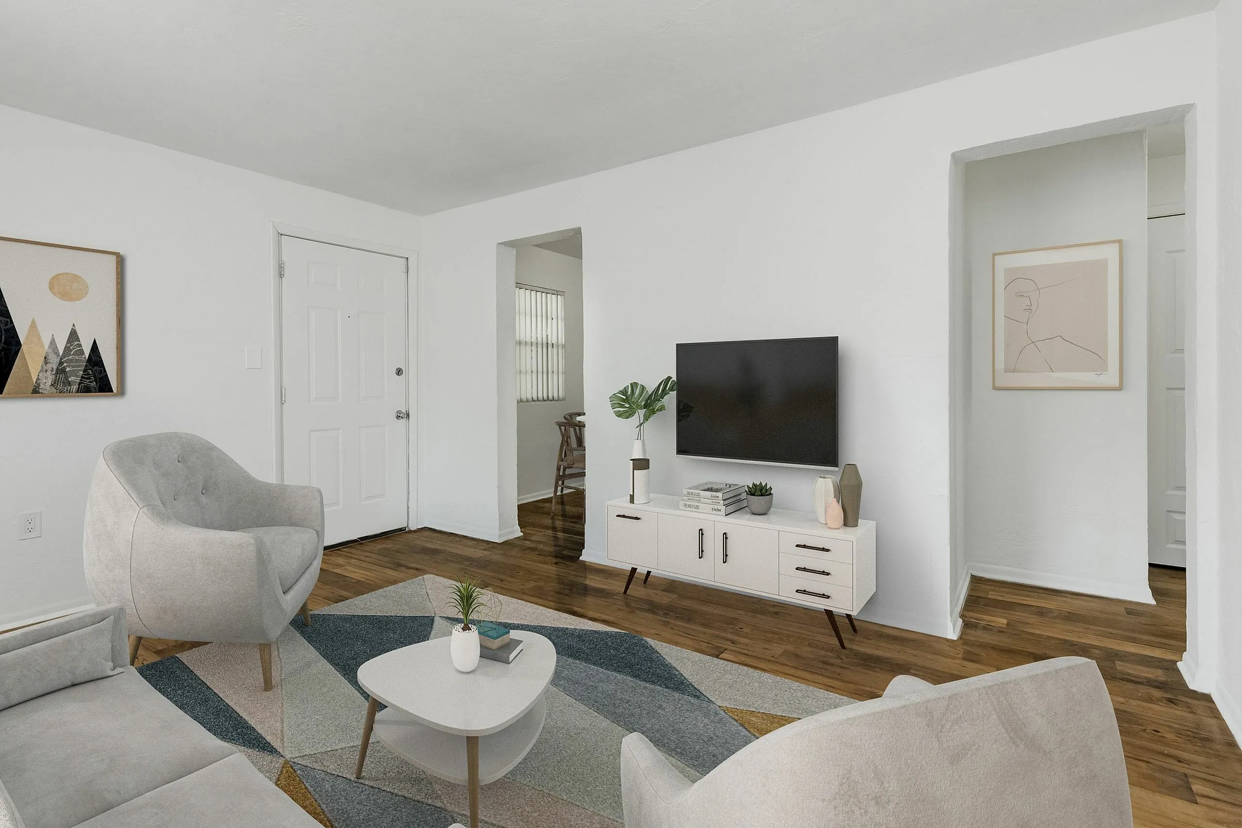 Chic modern living room with sleek decor, featuring stylish armchairs, a geometric rug, and a wall-mounted TV for a cozy atmosphere.