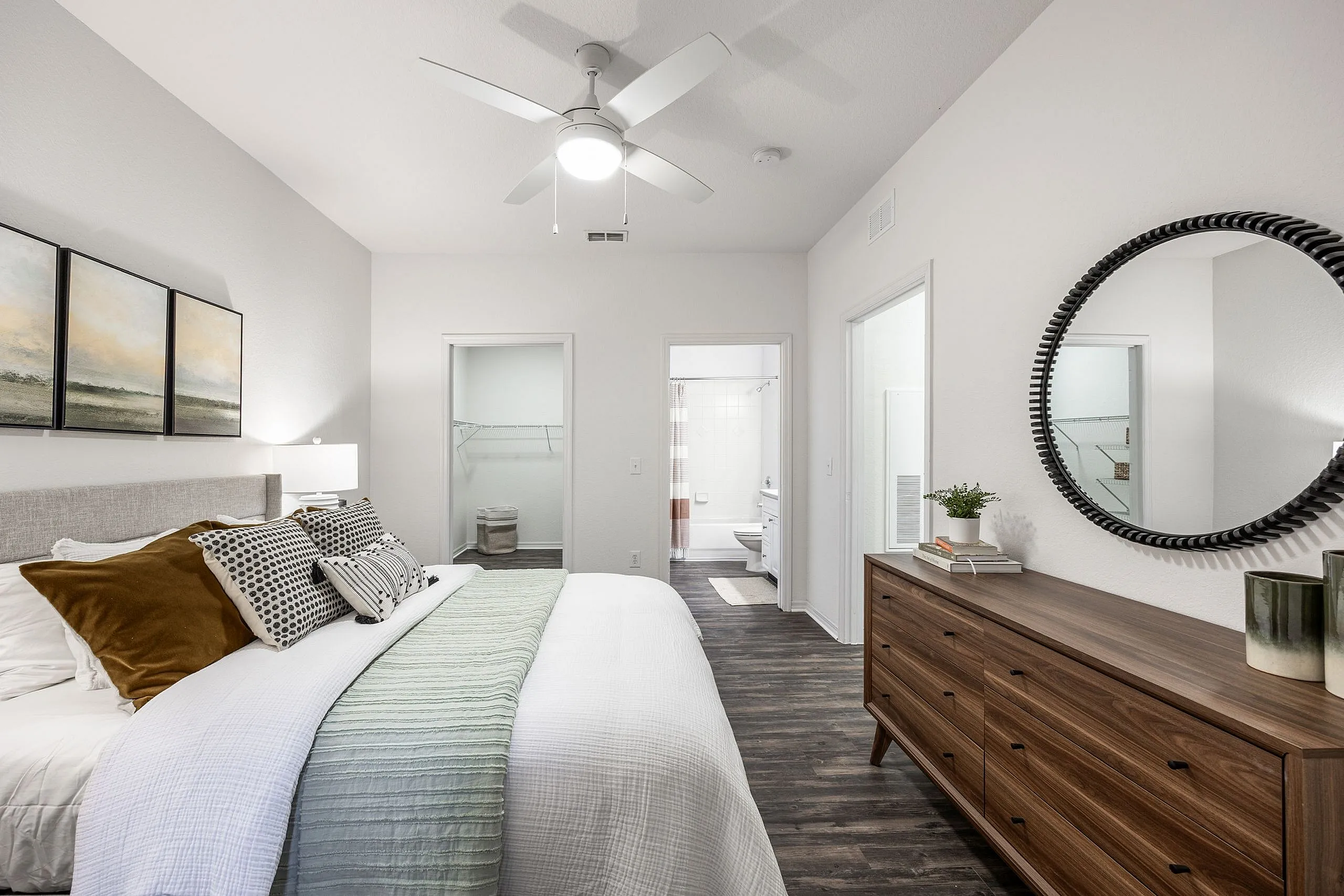 Chic bedroom with elegant decor, spacious walk-in closet, and modern ensuite bathroom, offering a serene living experience.