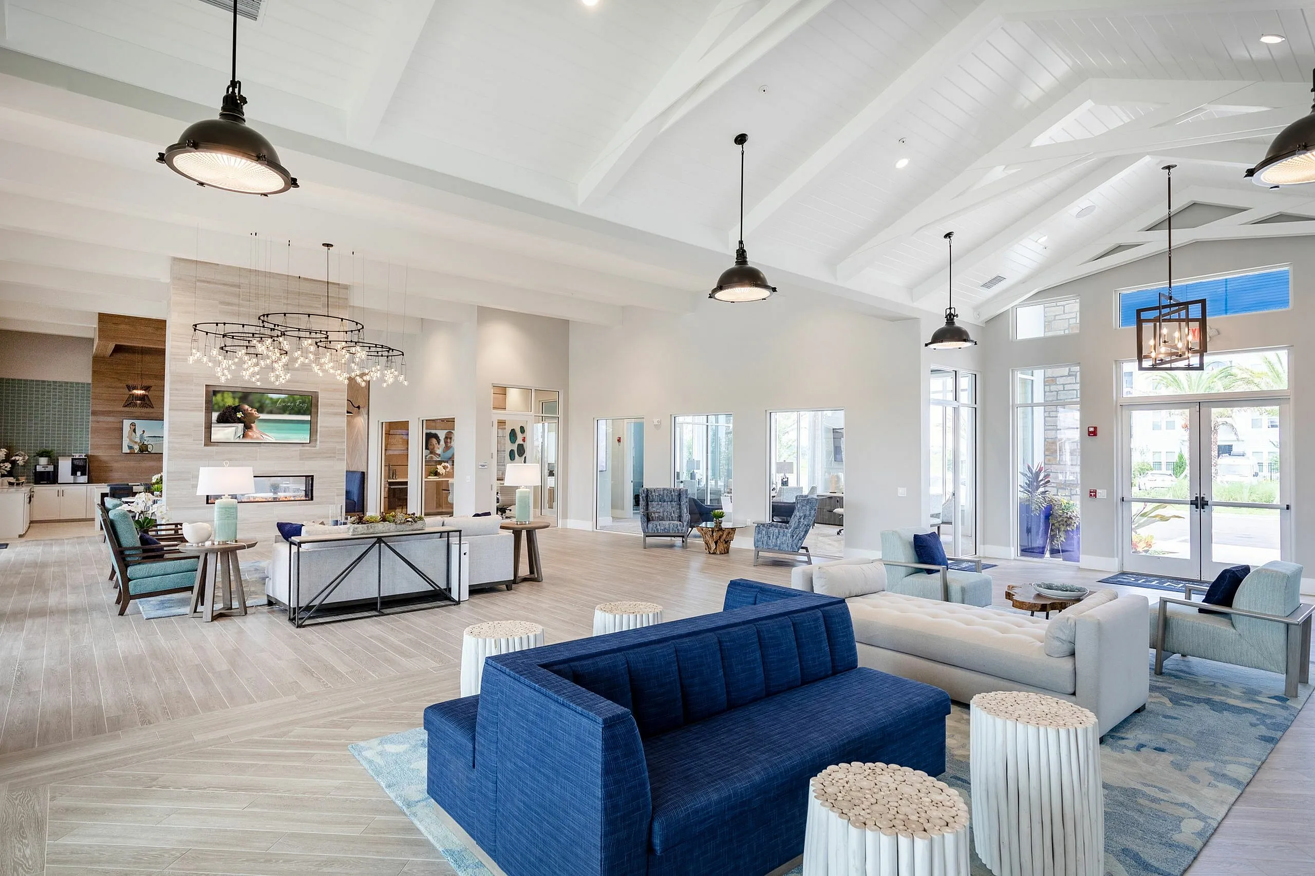 Elegant and spacious lounge area featuring modern seating, high ceilings, and abundant natural light.