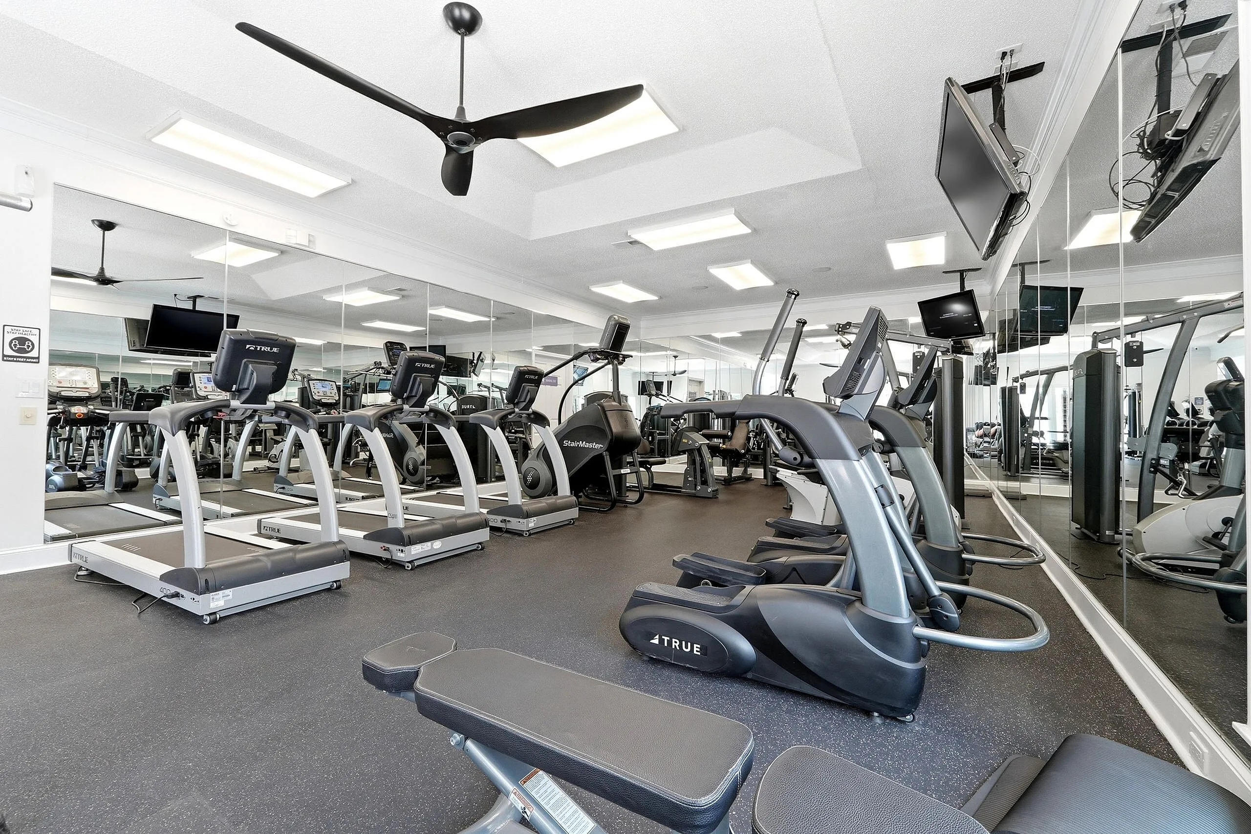 Modern fitness center equipped with state-of-the-art exercise machines and mirrored walls for a sleek workout experience.