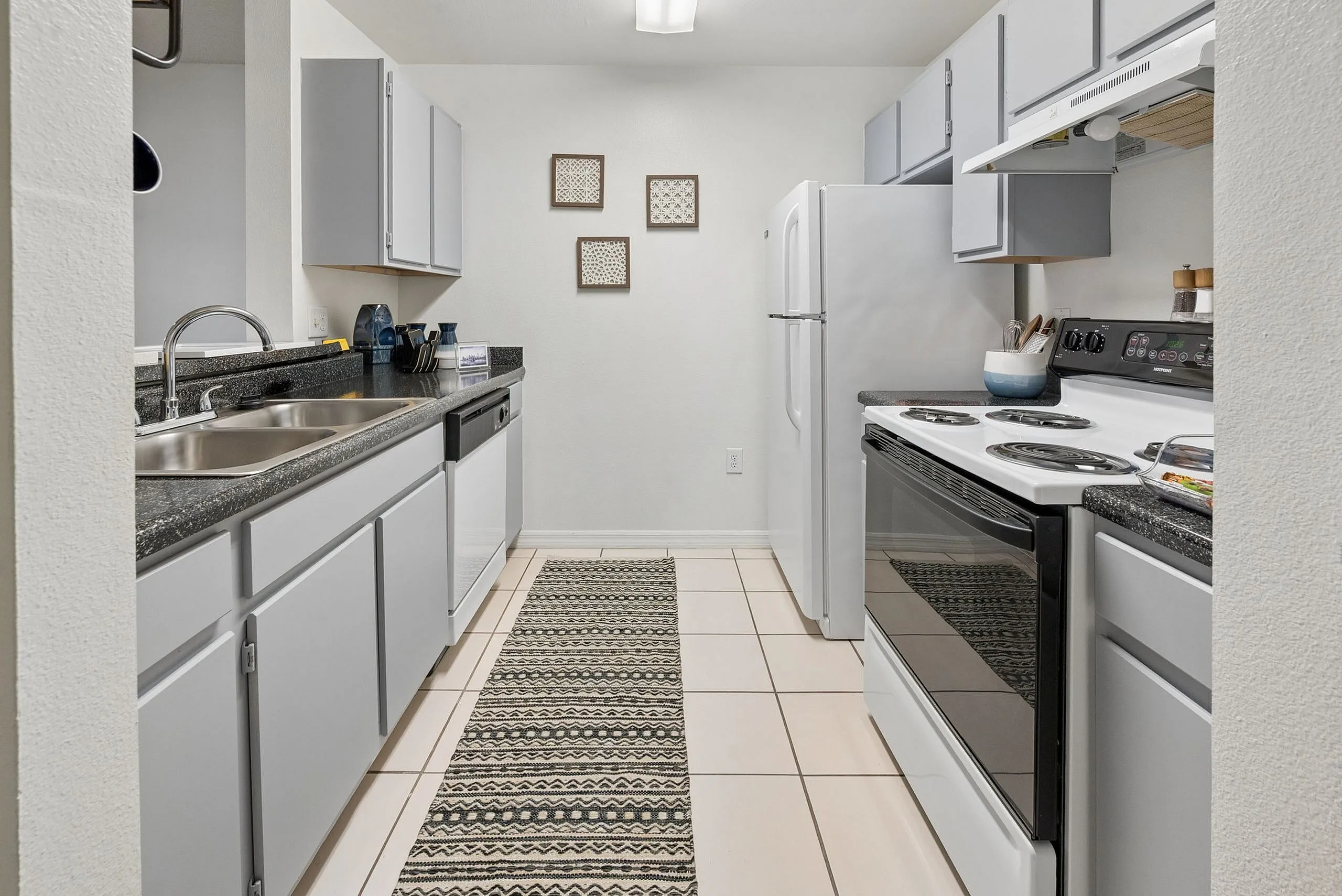 Chic galley kitchen featuring modern appliances, sleek countertops, and stylish cabinetry, perfect for culinary creations.