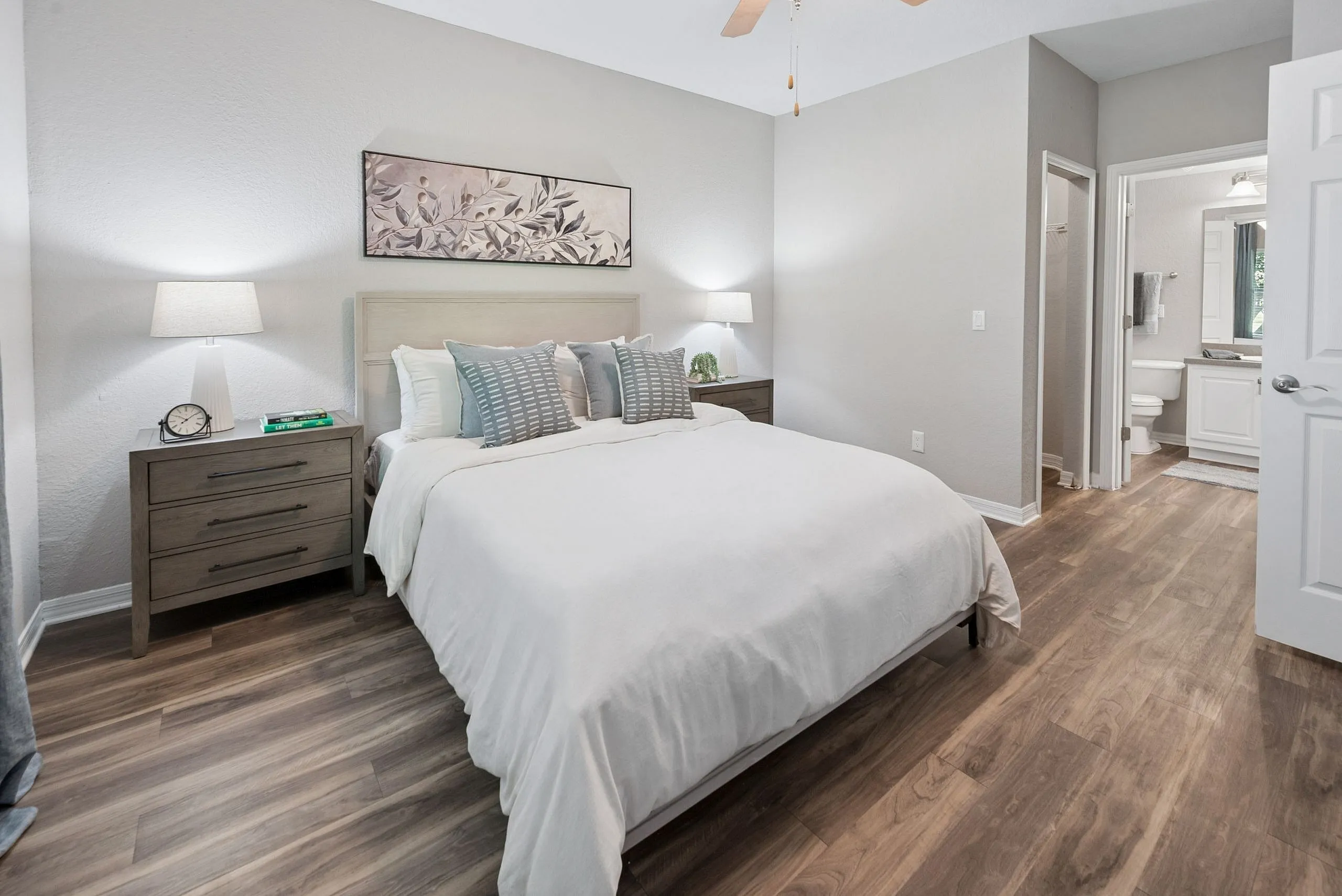 Inviting bedroom with elegant decor, featuring a plush bed, stylish nightstands, and modern ensuite bathroom.