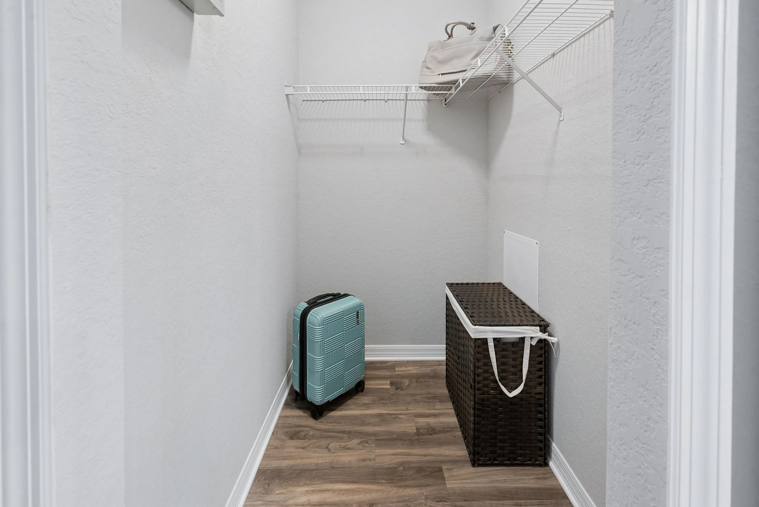Bright and spacious closet with sleek wooden flooring and ample storage space, ideal for an organized lifestyle.