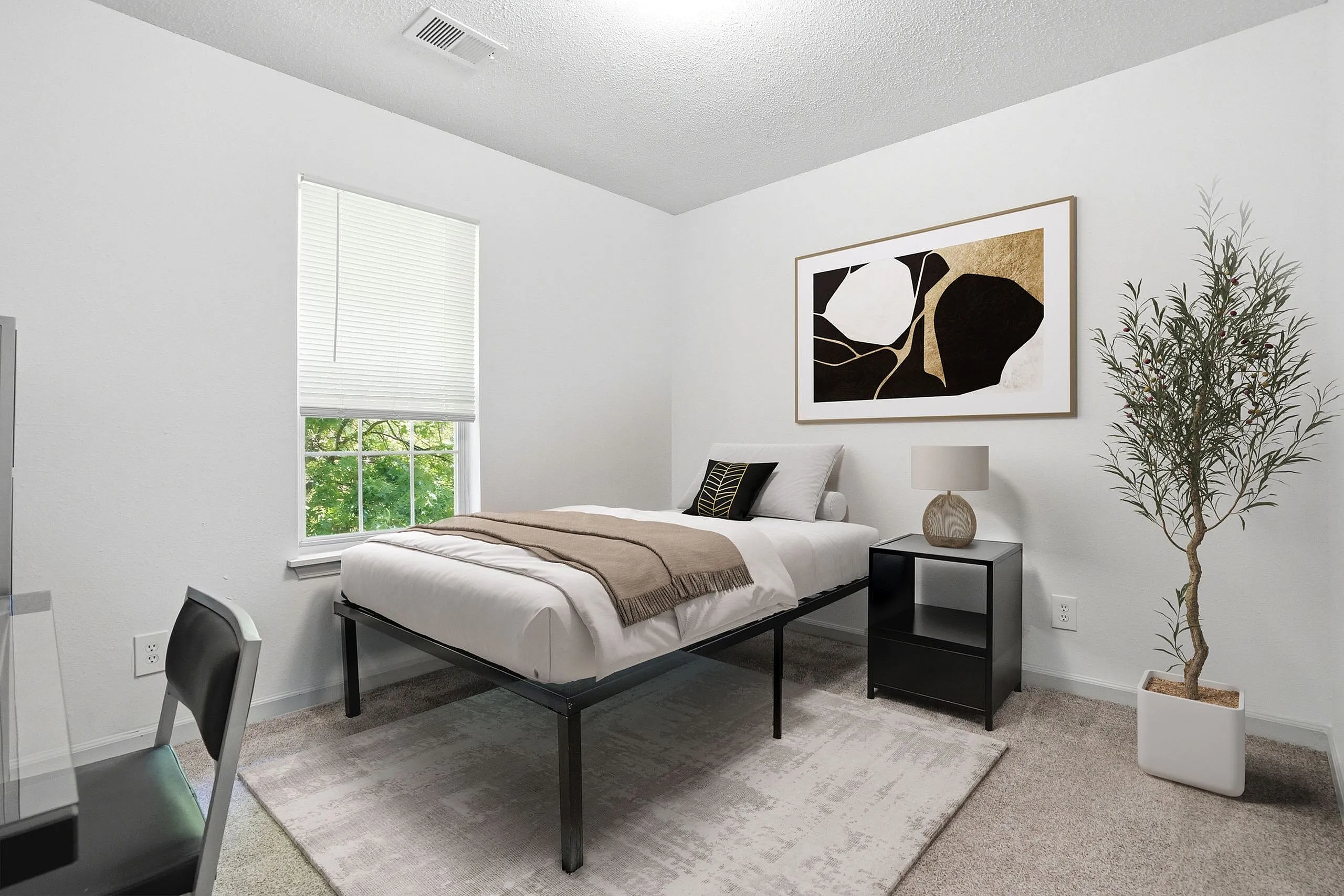 Bright and cozy bedroom with modern decor, featuring a comfortable single bed, stylish bedside table, and elegant artwork on the wall.