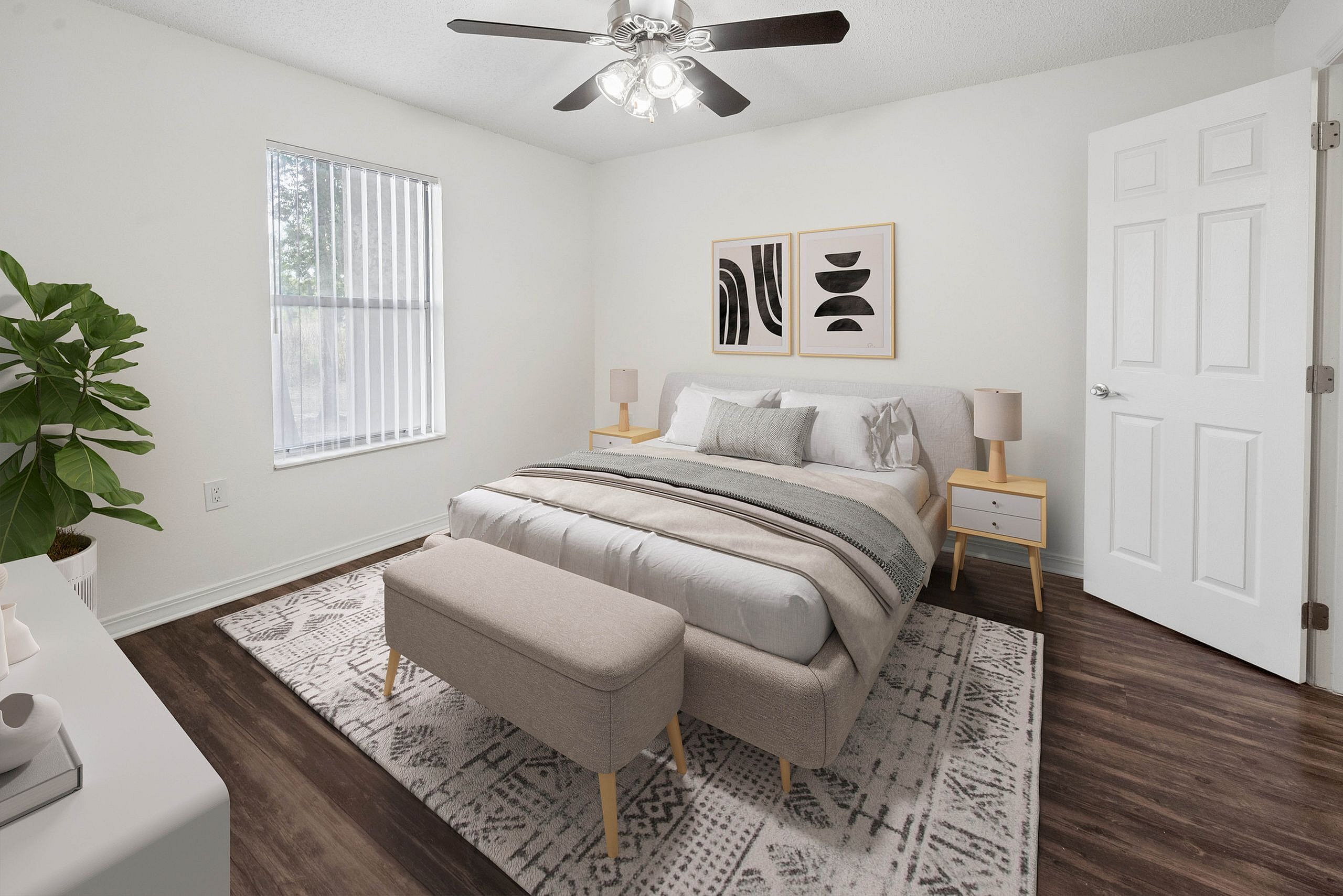 Chic bedroom with cozy gray bedding, modern decor, and natural light streaming through a large window, creating a tranquil retreat.