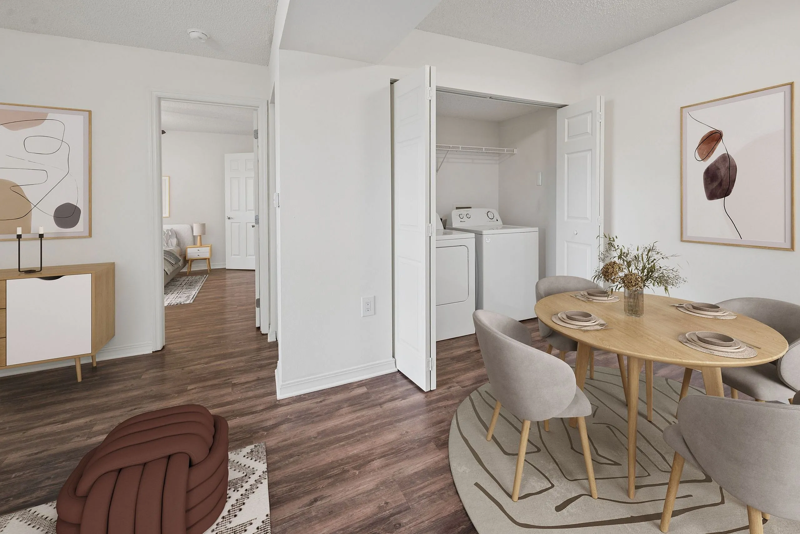 Inviting apartment interior showcasing a cozy dining area with chic decor, alongside a convenient in-unit washer and dryer set.
