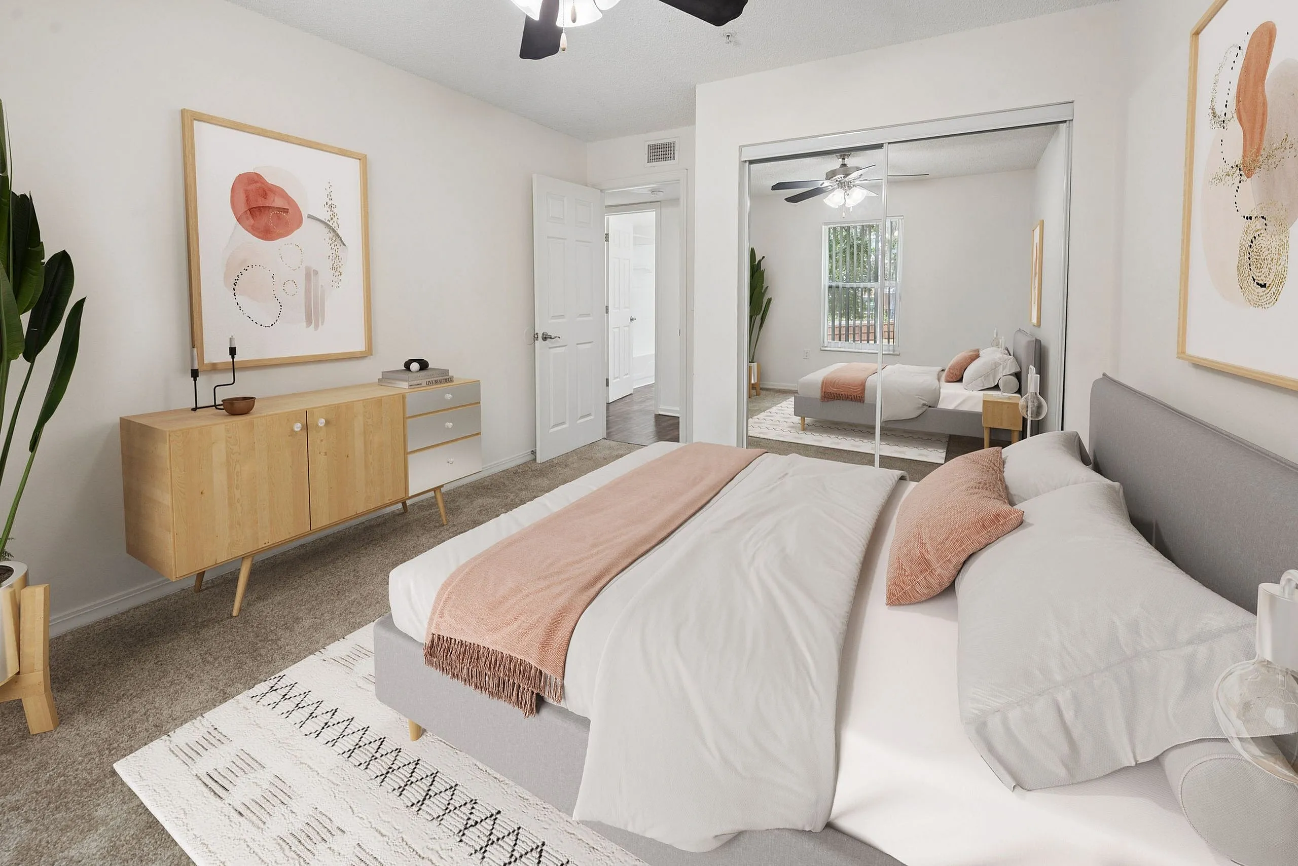 Inviting bedroom with modern decor, featuring a cozy bed with stylish peach accents, elegant wall art, and a chic wooden dresser.