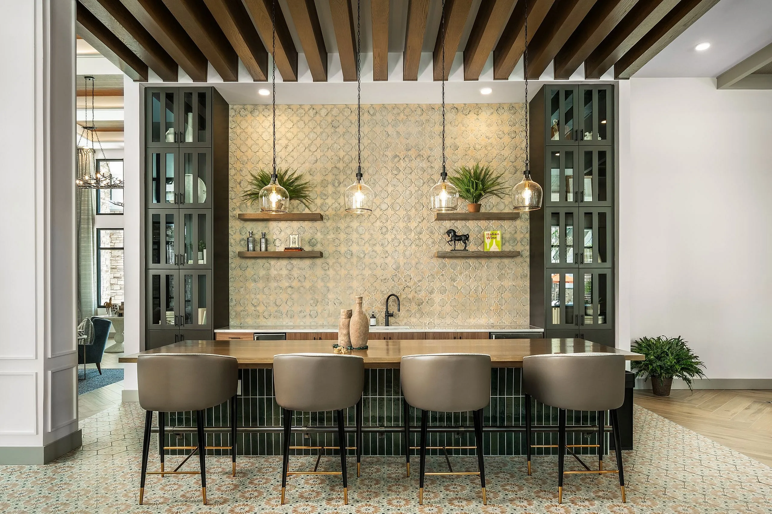 Elegant apartment bar with modern pendant lighting, chic seating, and stylish open shelving with decorative plants.