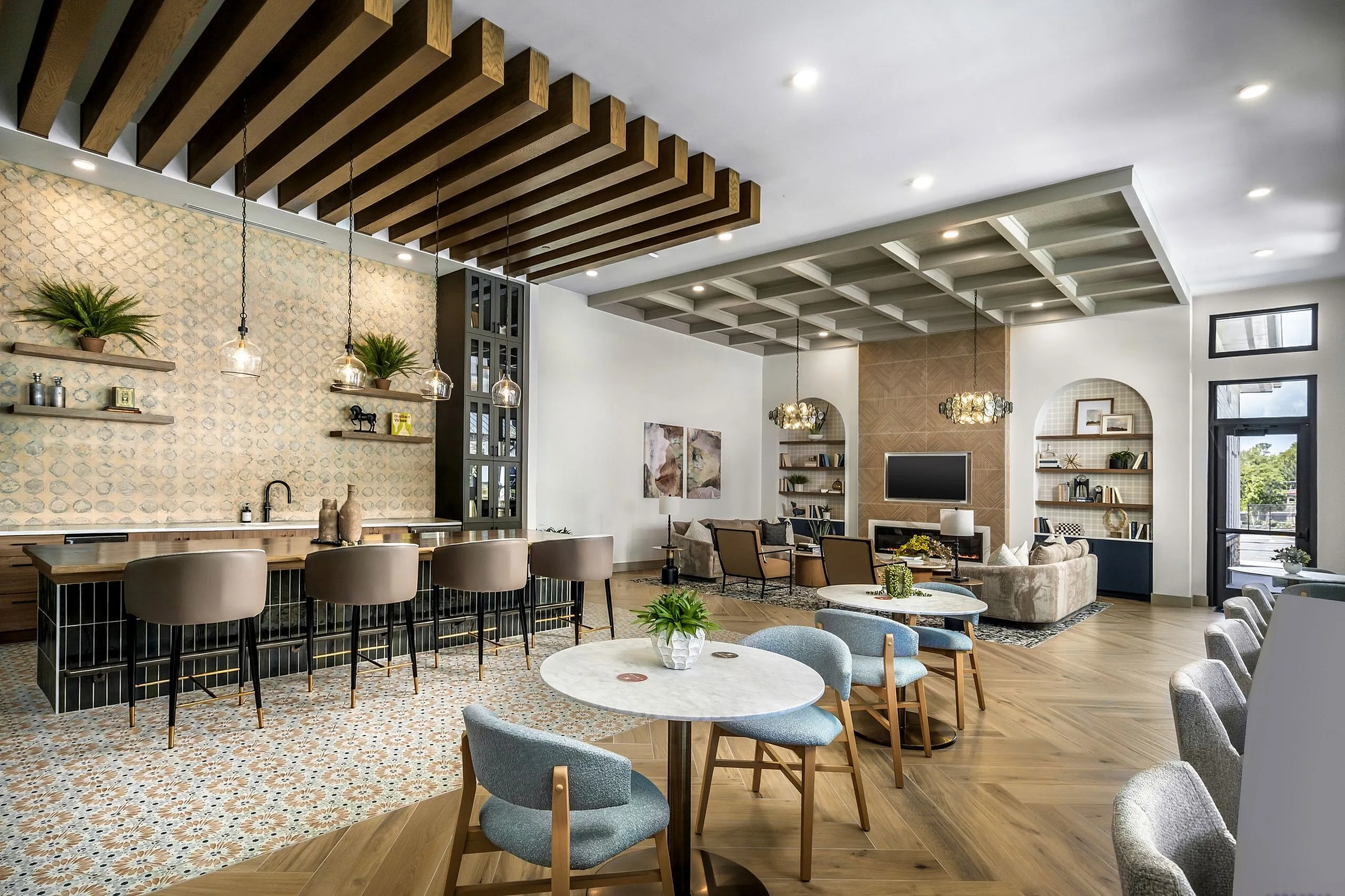 Chic and modern open-concept living and dining area with stylish bar seating, elegant lighting, and cozy lounge space.
