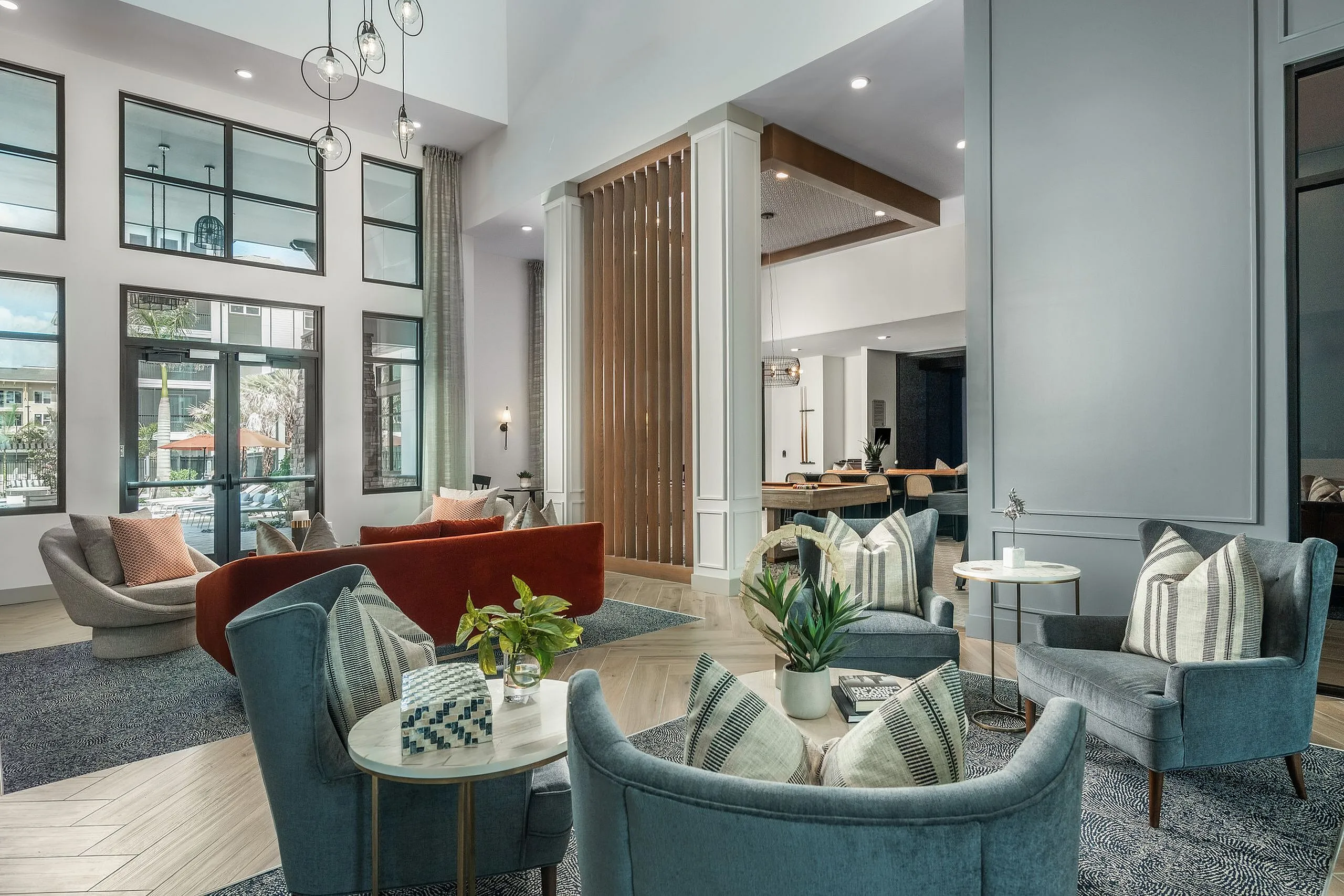 Inviting modern lounge space with plush seating, stylish decor, and large windows offering natural light.