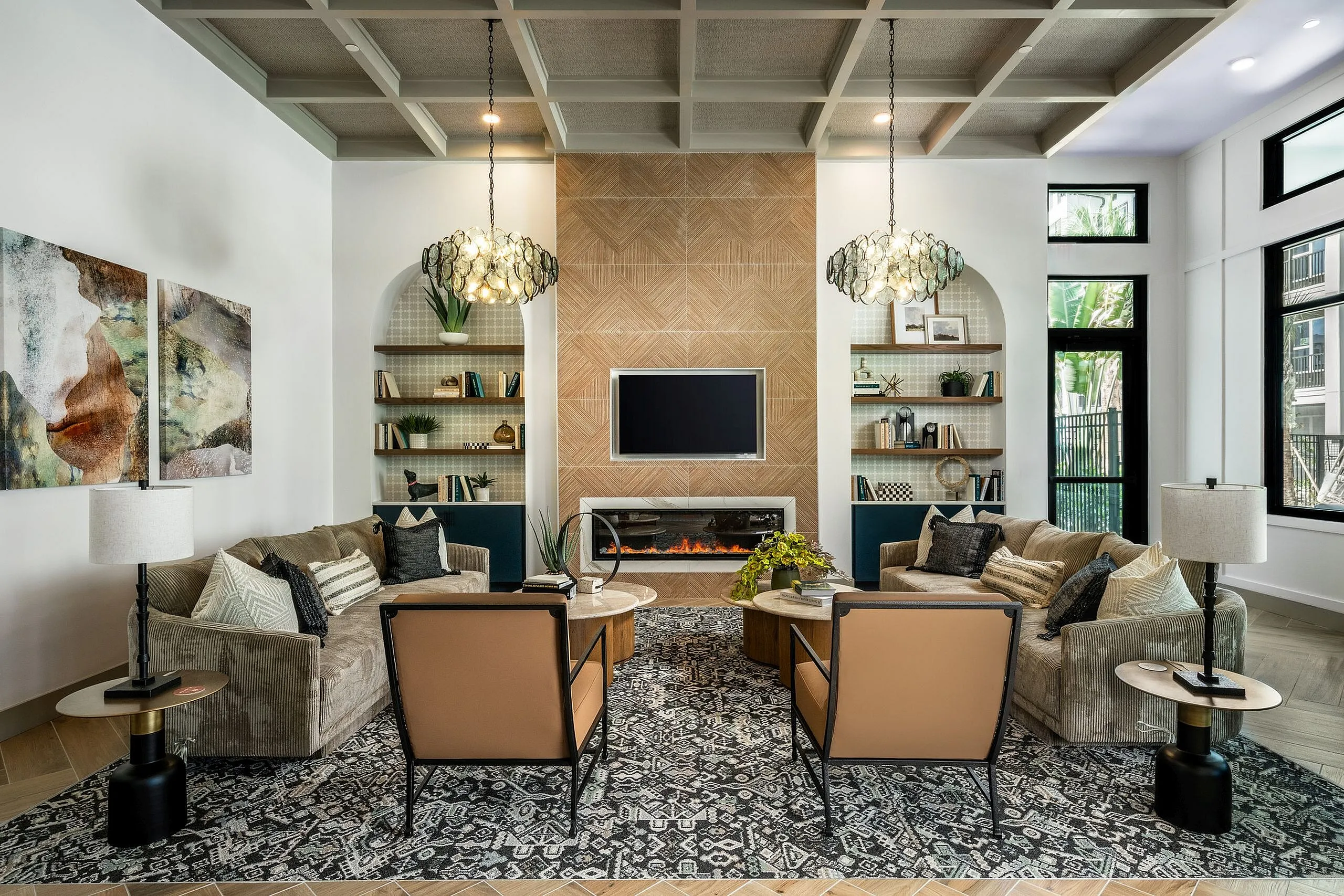 Elegant living room with modern decor, featuring plush sofas, stylish chandeliers, and a cozy fireplace, perfect for relaxation and entertaining.