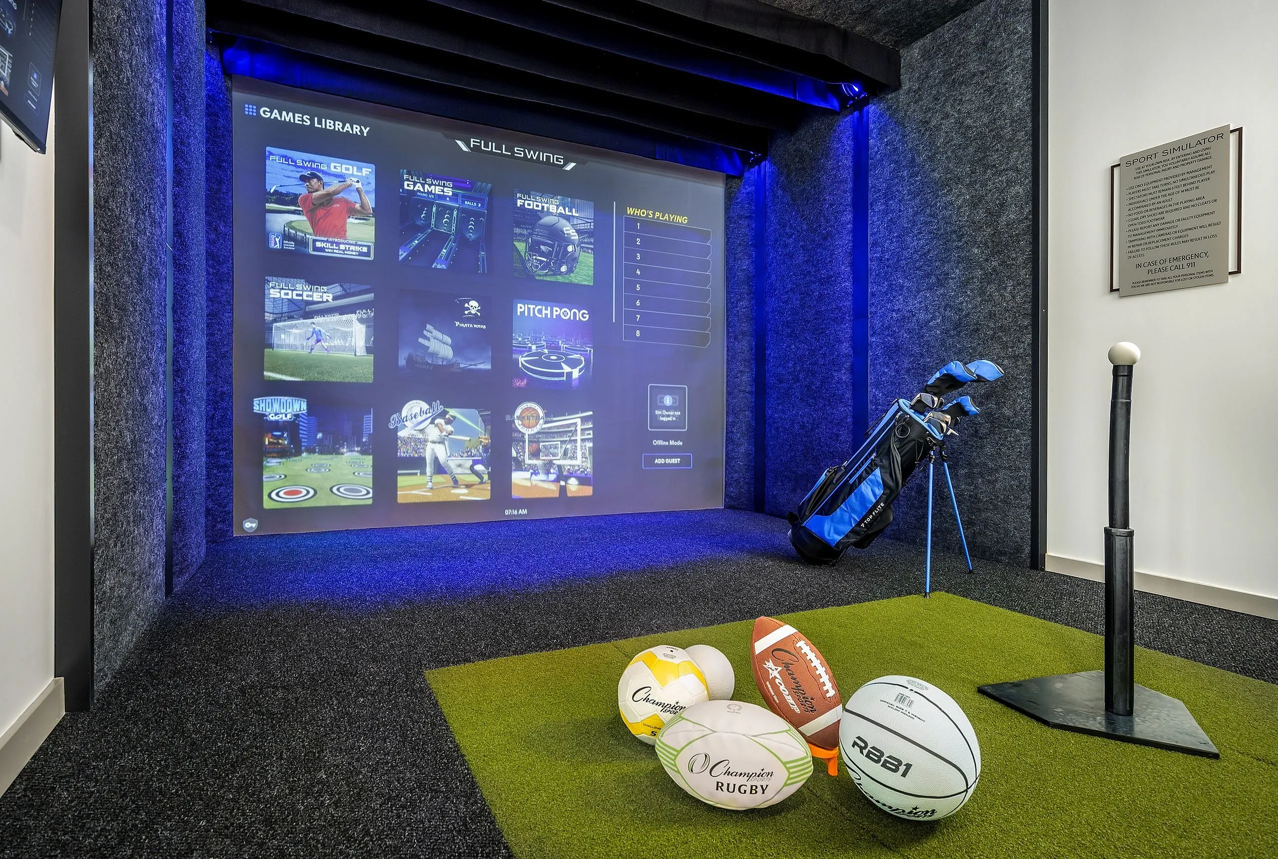 Luxurious sports simulator room featuring interactive game screen, golf equipment, and various sports balls, offering a premium entertainment experience.