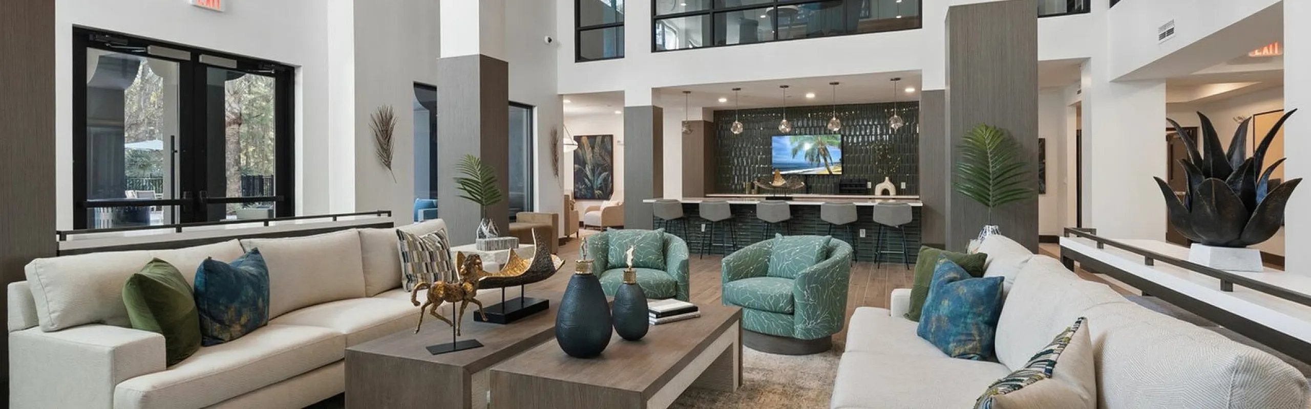 Luxurious modern living room with high ceilings, elegant couches, and a stylish open layout, featuring contemporary decor and a chic communal area.