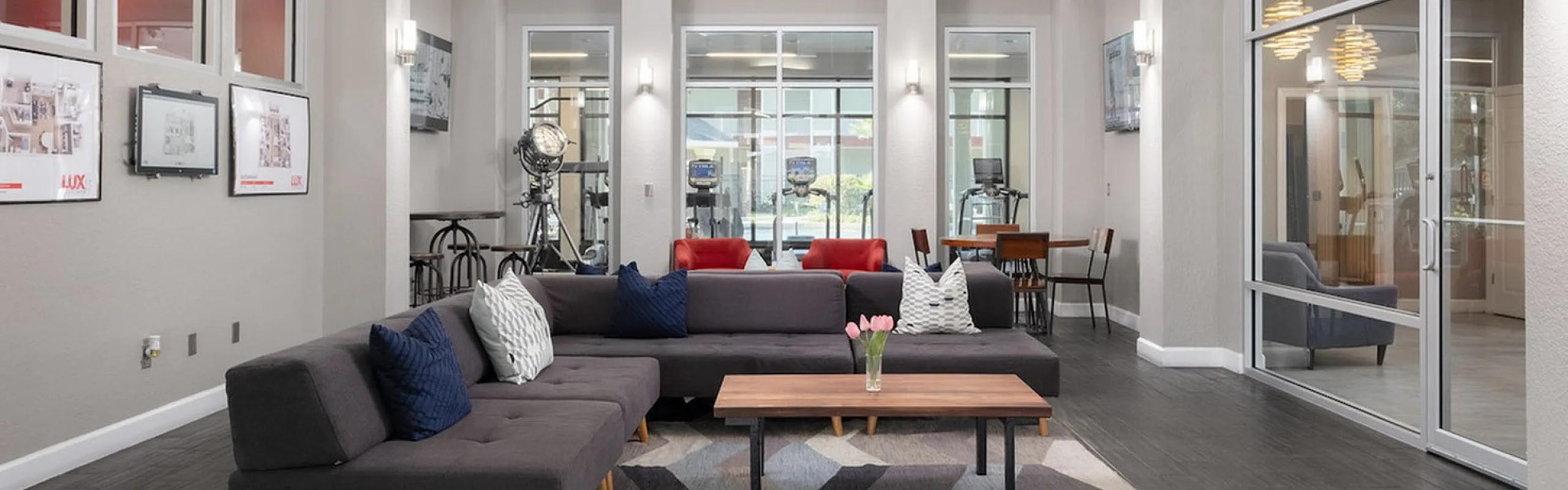 Luxurious communal living area with modern decor, featuring stylish light fixtures and vibrant artwork, perfect for relaxation and gatherings.