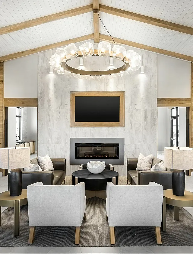 Sophisticated modern living room with elegant chandelier, cozy fireplace, and stylish seating area in a beautifully designed home.