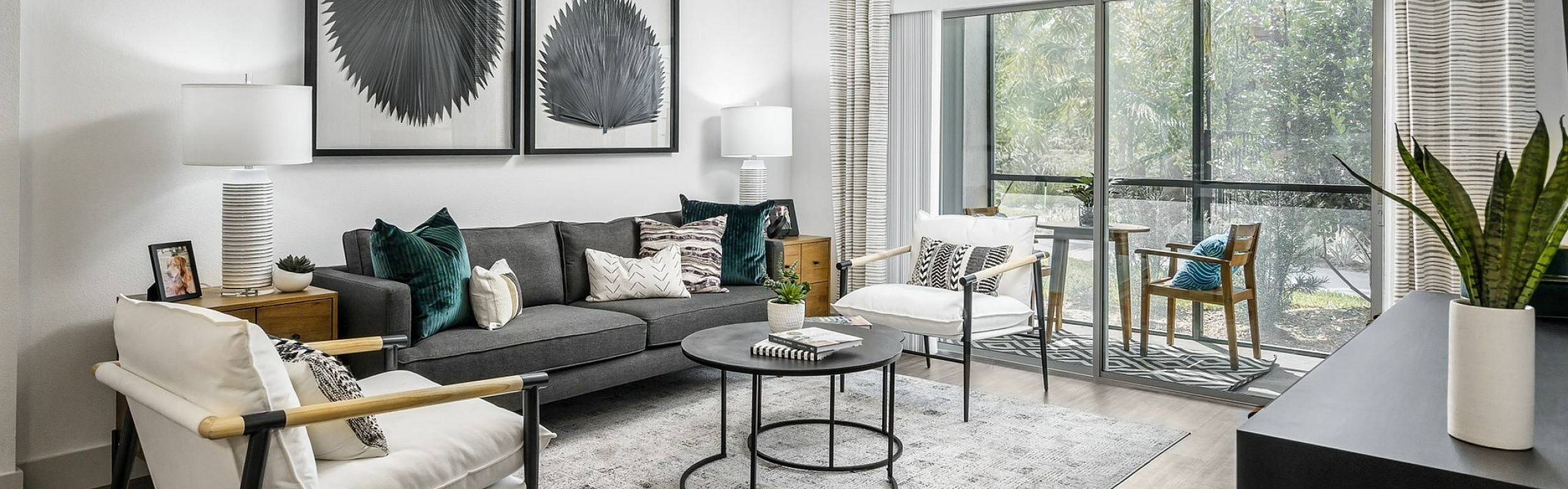 Bright and modern living room with sleek furnishings, large windows, and elegant decor creating a welcoming ambiance.