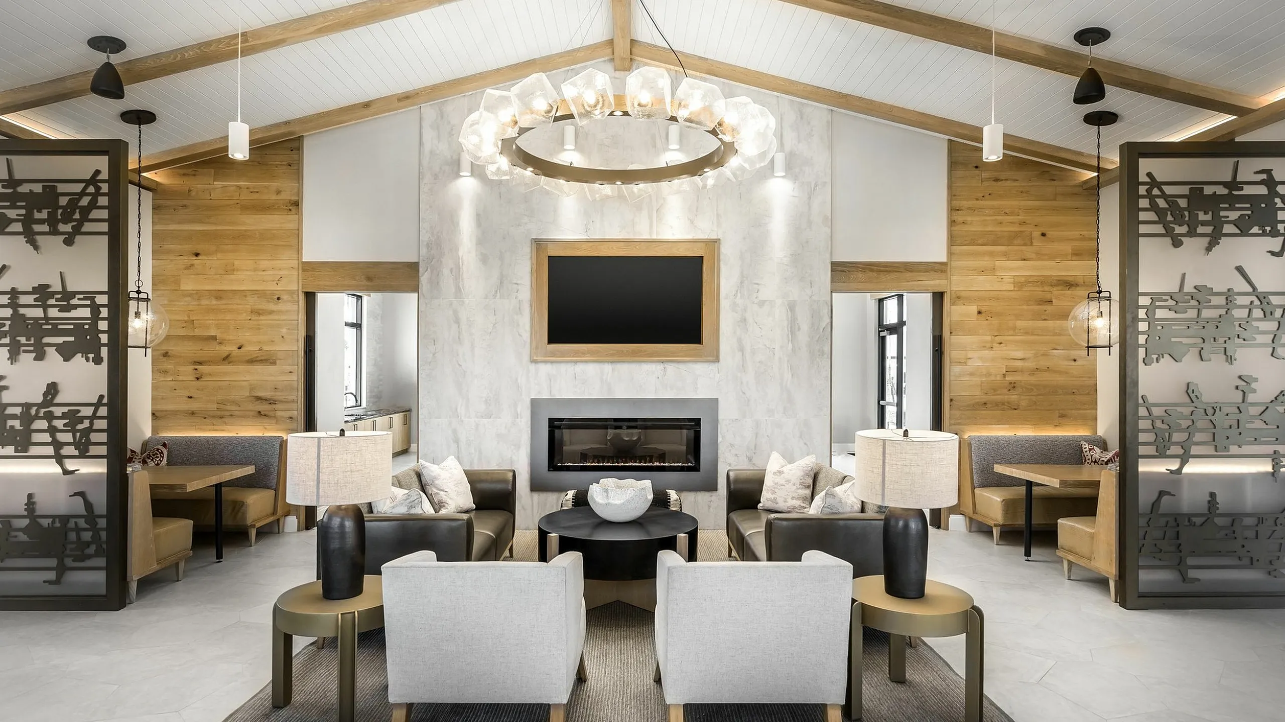 Luxurious and modern living room with elegant chandelier, cozy fireplace, and stylish seating area, exuding warmth and sophistication.