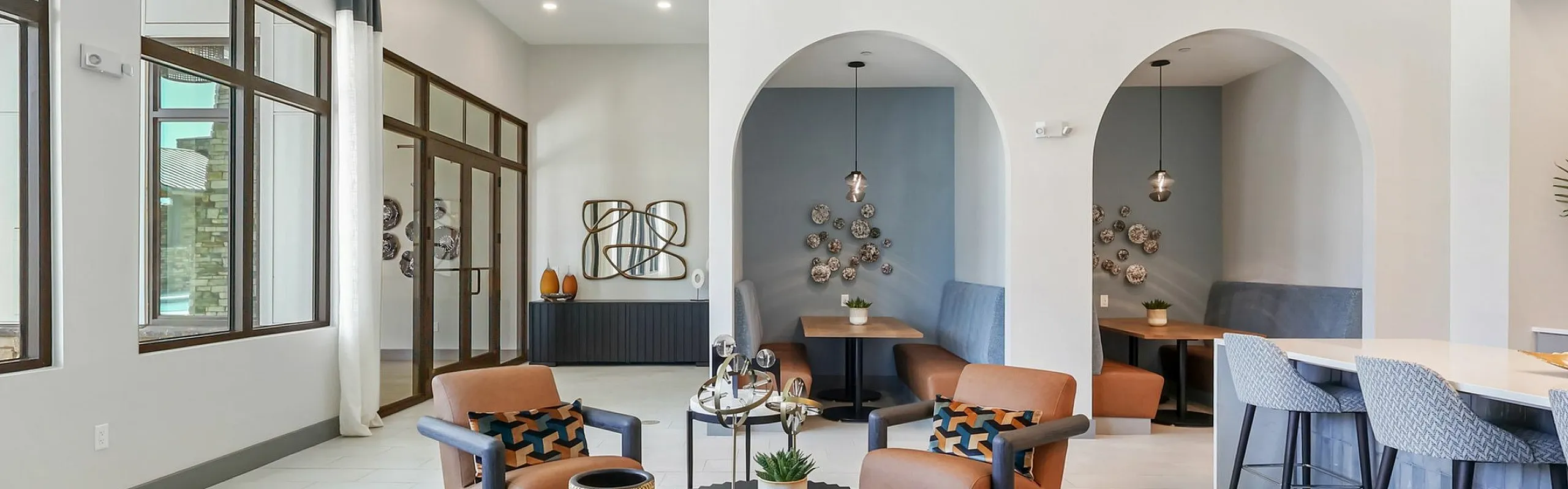 Inviting modern lounge with stylish seating, elegant decor, and abundant natural light.