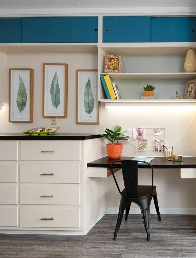Chic apartment interior with built-in desk, open shelving, and stylish storage solutions in a modern color palette.