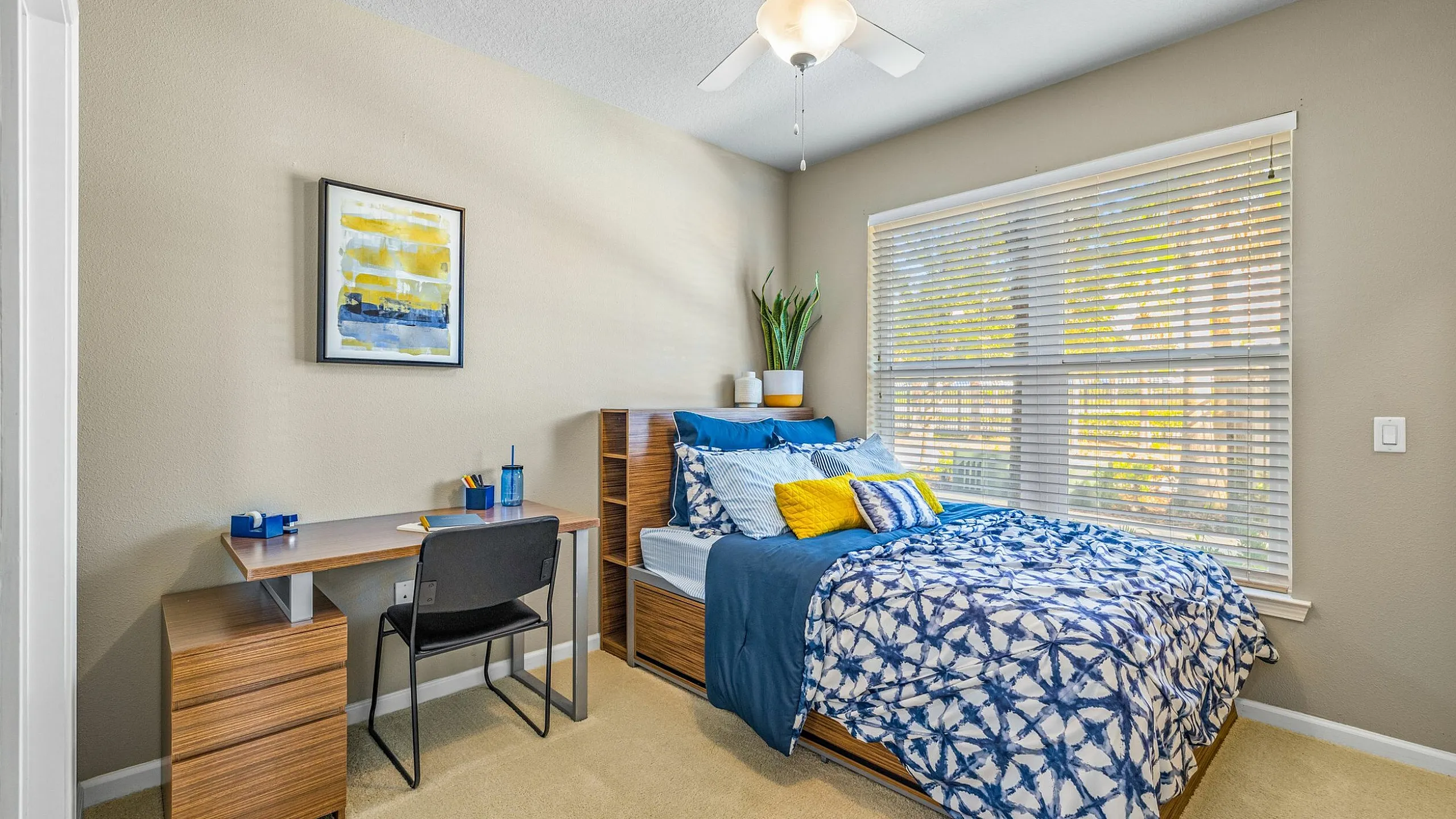 Bright and modern bedroom with a cozy bed, elegant decor, and ample natural light through large windows.
