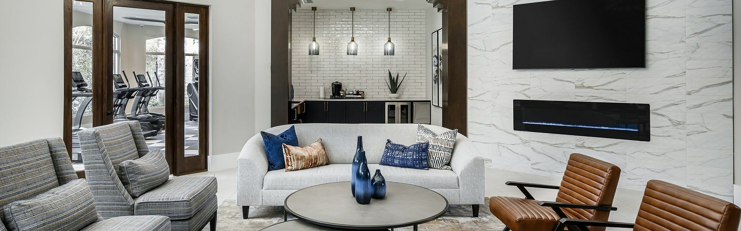 Sophisticated modern living room featuring plush seating, elegant chandelier, cozy fireplace, and stylish decor for a luxurious ambiance.