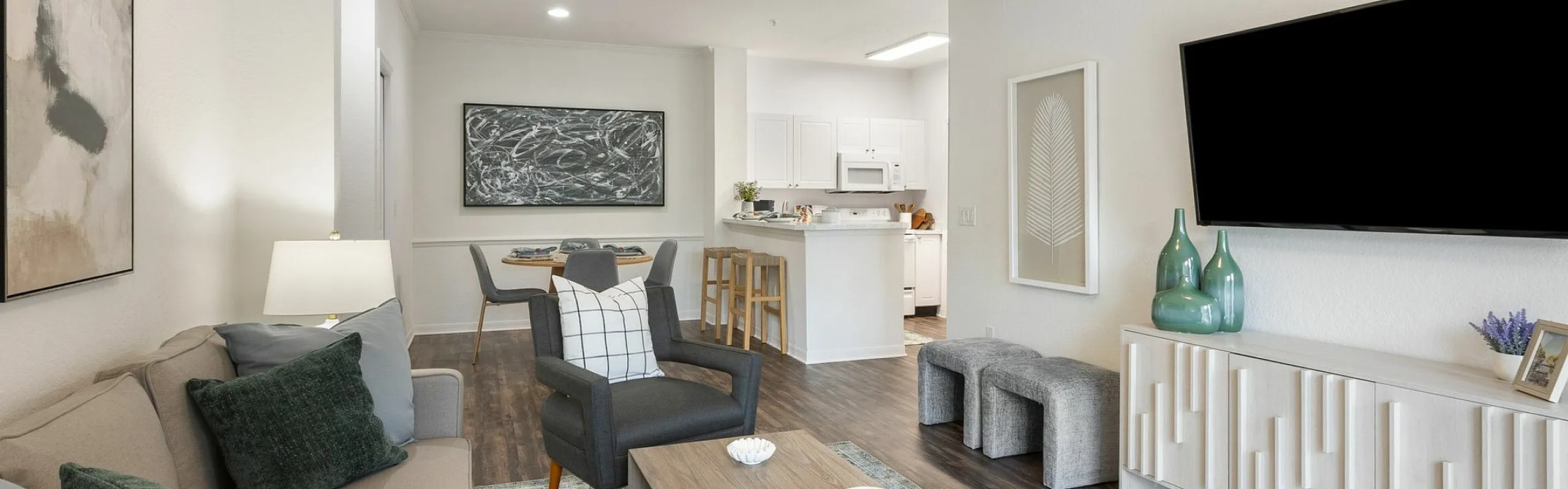 Chic and modern living room with stylish furniture, elegant decor, and open kitchen area, perfect for entertaining.