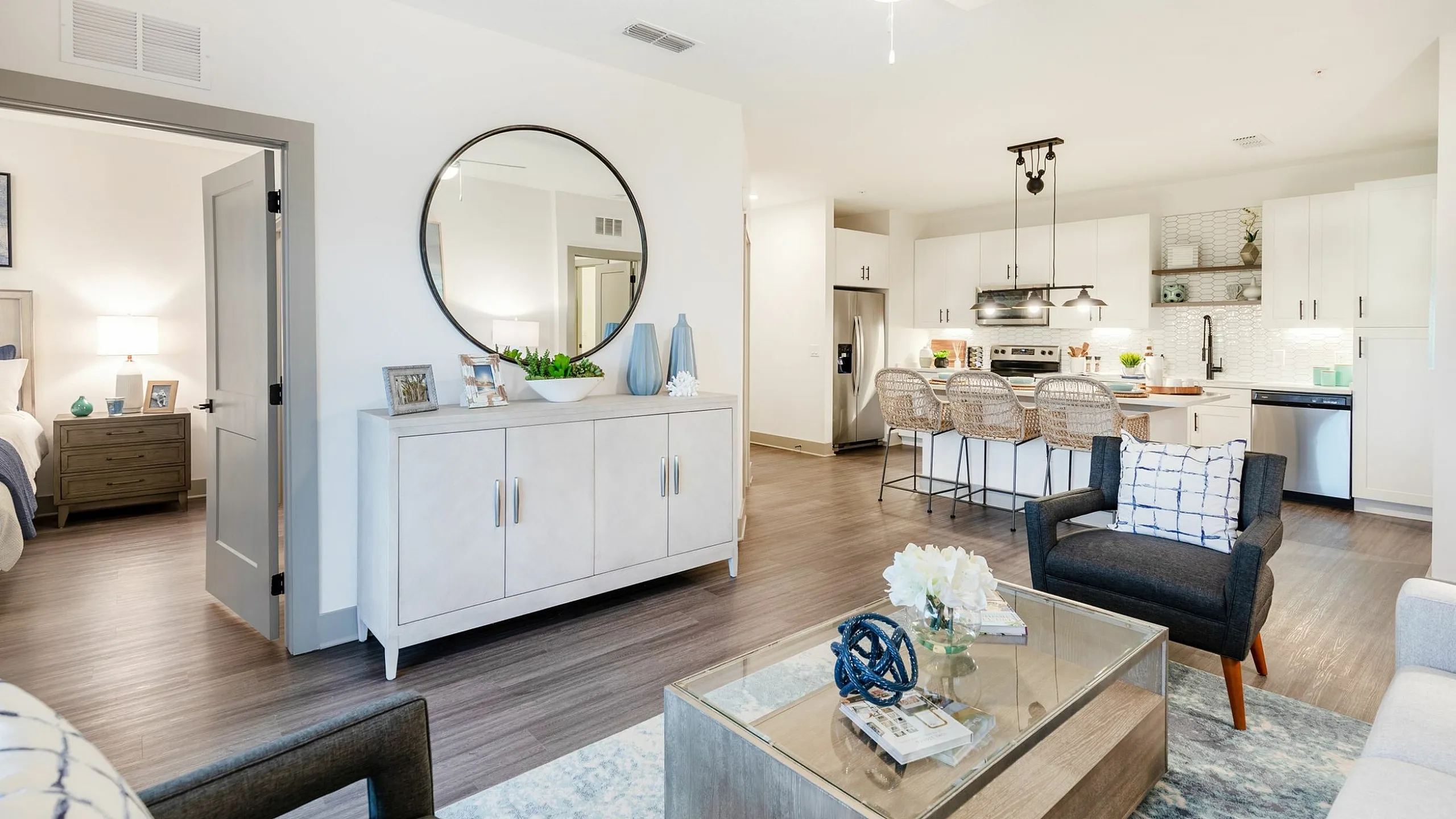 Modern open-concept living area with chic kitchen, stylish decor, and cozy seating, inviting comfort and elegance.