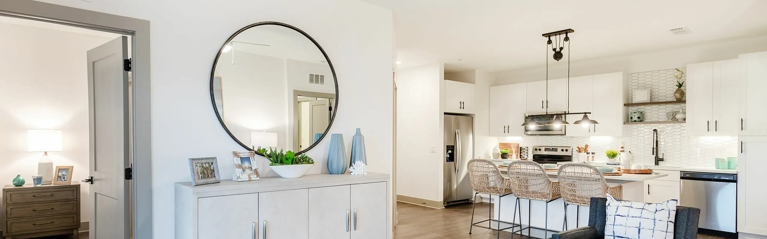 Bright and modern open-concept living area with elegant decor, sleek kitchen island, and cozy seating, perfect for contemporary living.
