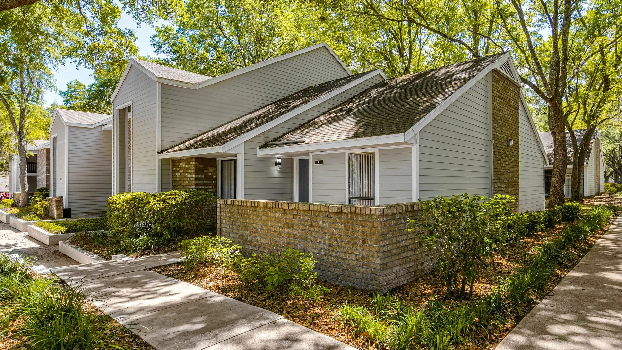 Charming suburban apartment with contemporary design, lush landscaped surroundings, and inviting pathways.