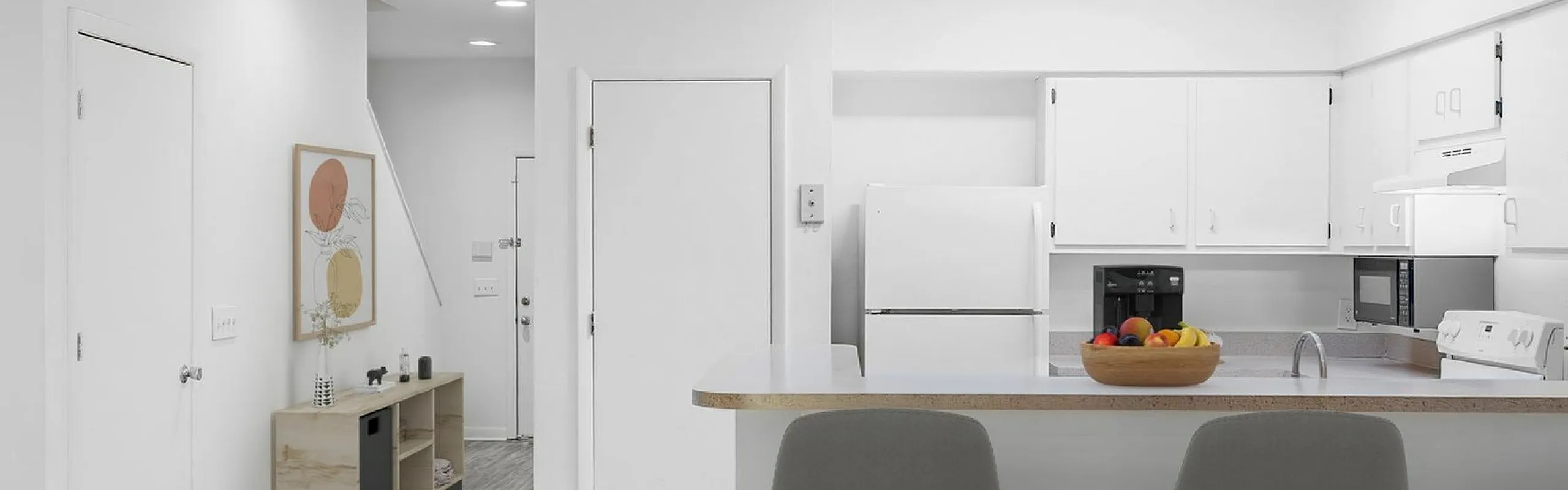 Modern open-concept kitchen and dining area with sleek decor, neutral tones, and stylish lighting.