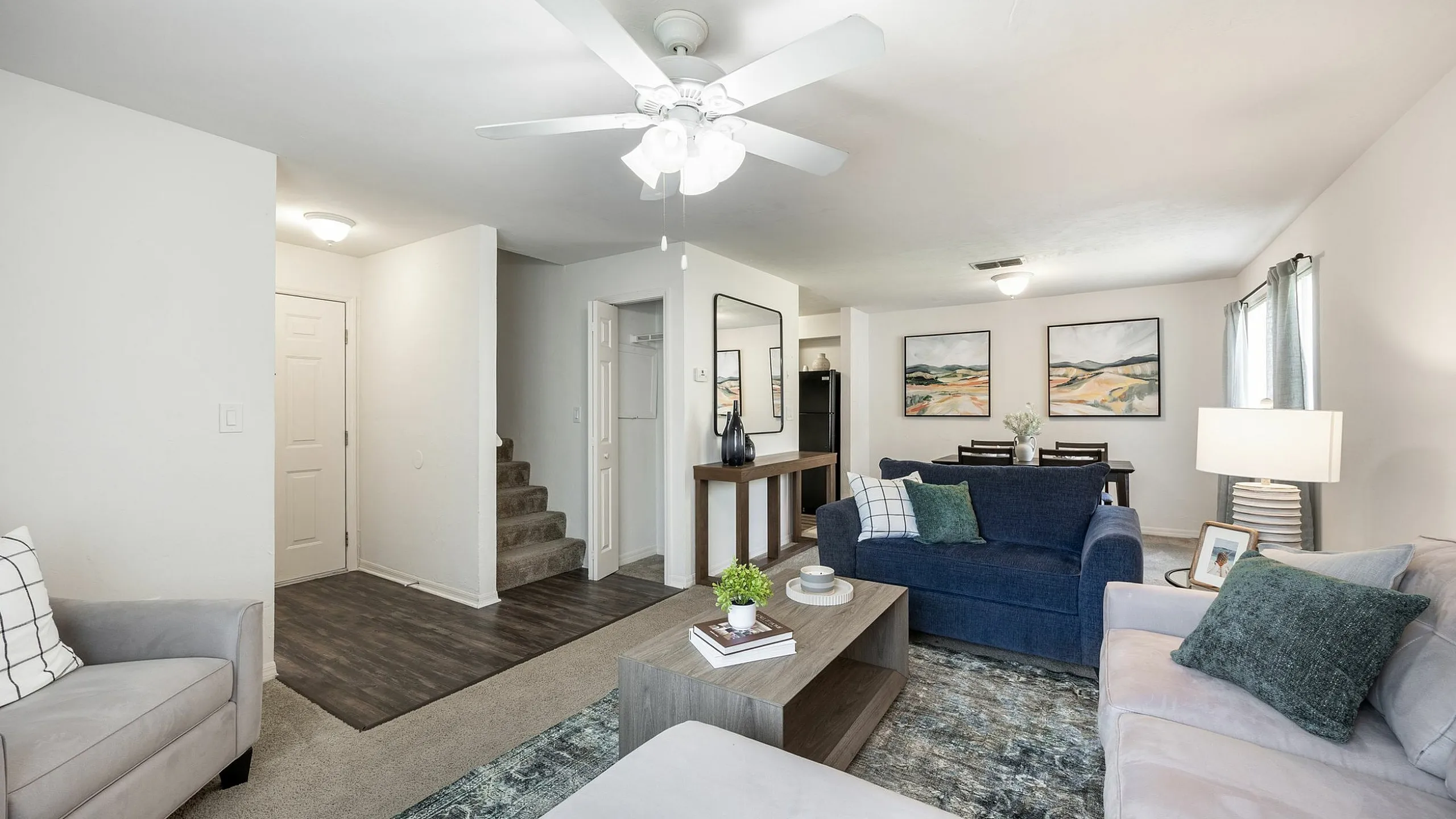 Inviting living space featuring cozy seating, a stylish coffee table, modern decor, and natural light, perfect for relaxation.