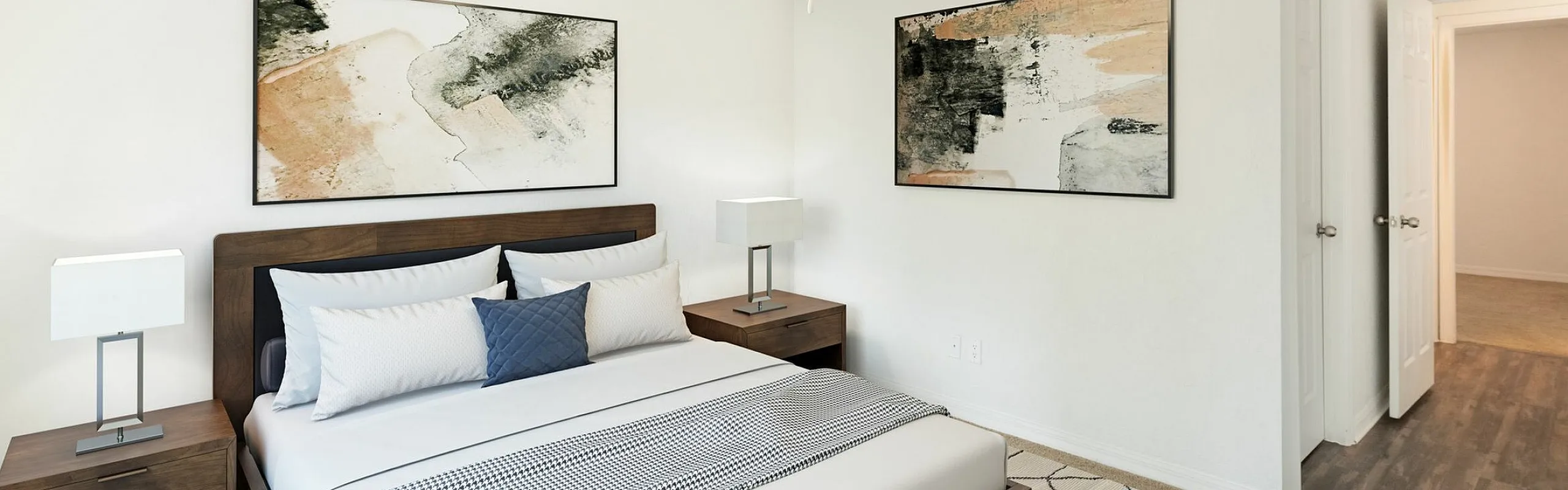 Inviting modern bedroom with elegant decor, featuring a wooden bed frame, sleek nightstands, and abstract artwork, offering a serene and stylish retreat.